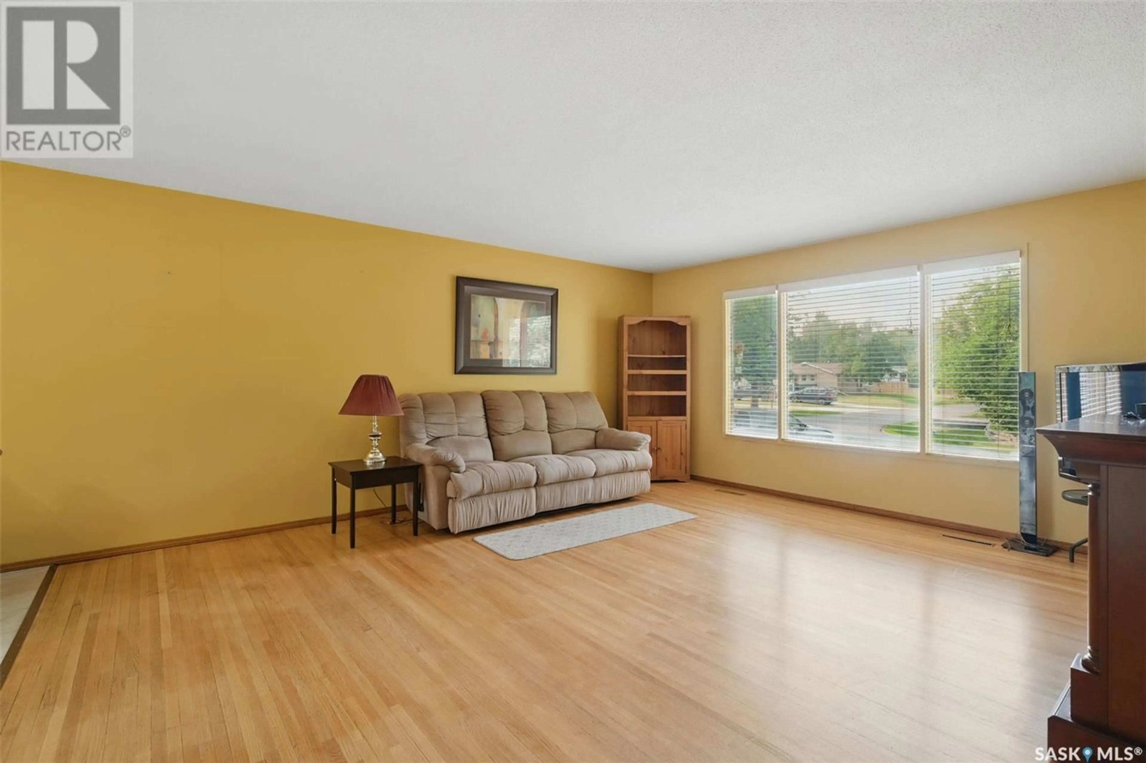 Living room with furniture, wood/laminate floor for 1658 BADER CRESCENT, Saskatoon Saskatchewan S7M3V3