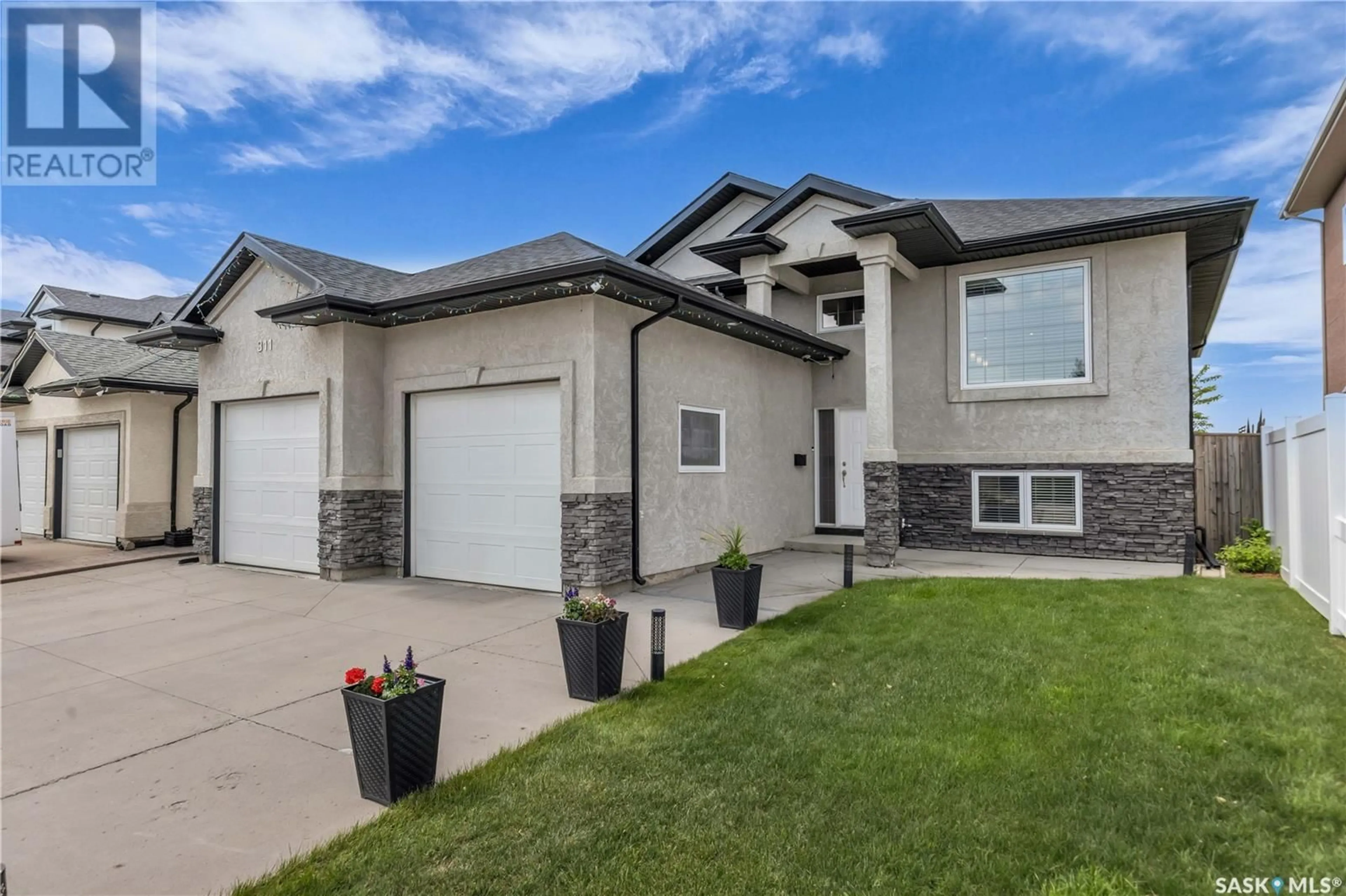 Home with vinyl exterior material, street for 311 WATERS CRESCENT, Saskatoon Saskatchewan S7W0A5