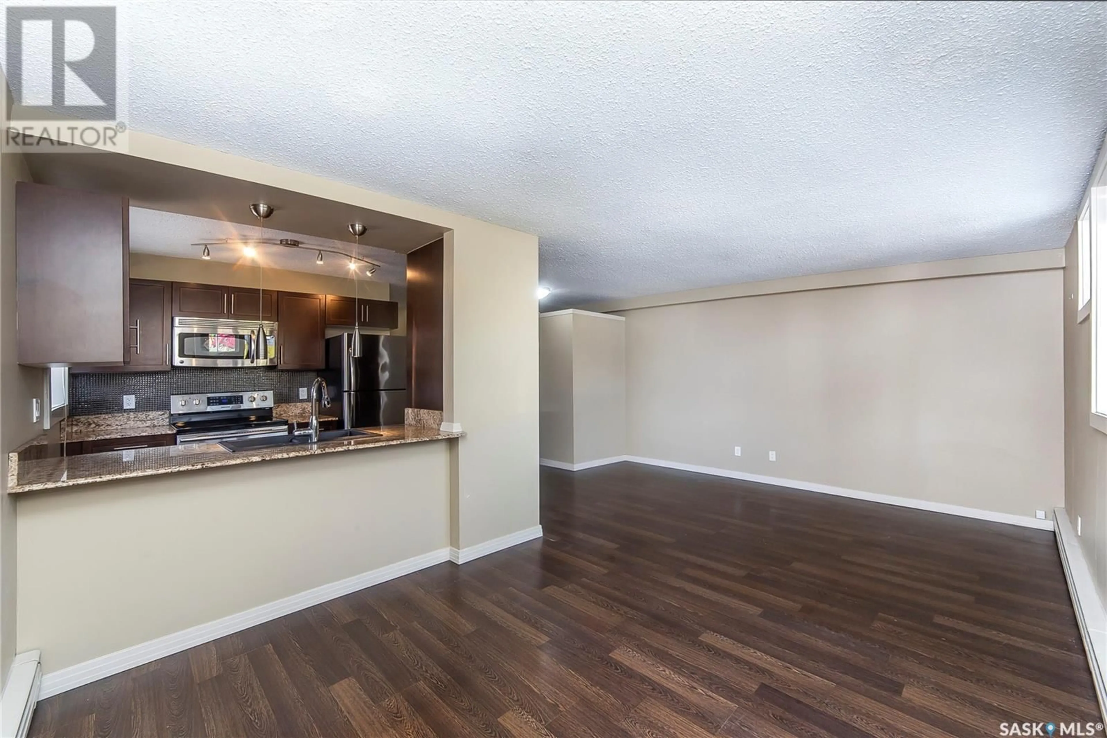 Open concept kitchen, wood/laminate floor for 101 - 2613 BROADWAY AVENUE, Saskatoon Saskatchewan S7J0R7