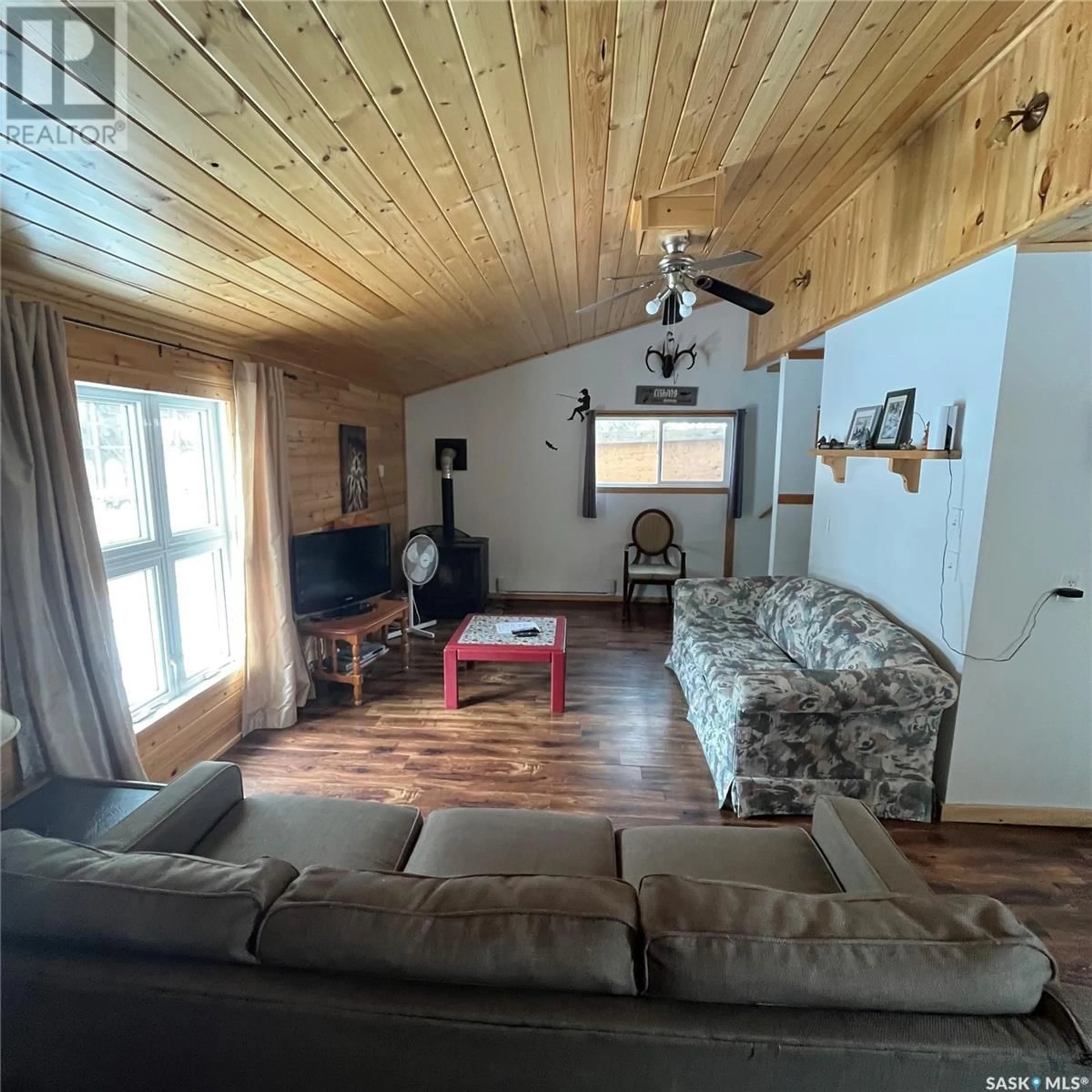 Living room with furniture, wood/laminate floor for 212 RICHARD DRIVE, Barrier Valley Rm No. 397 Saskatchewan S0E0B0