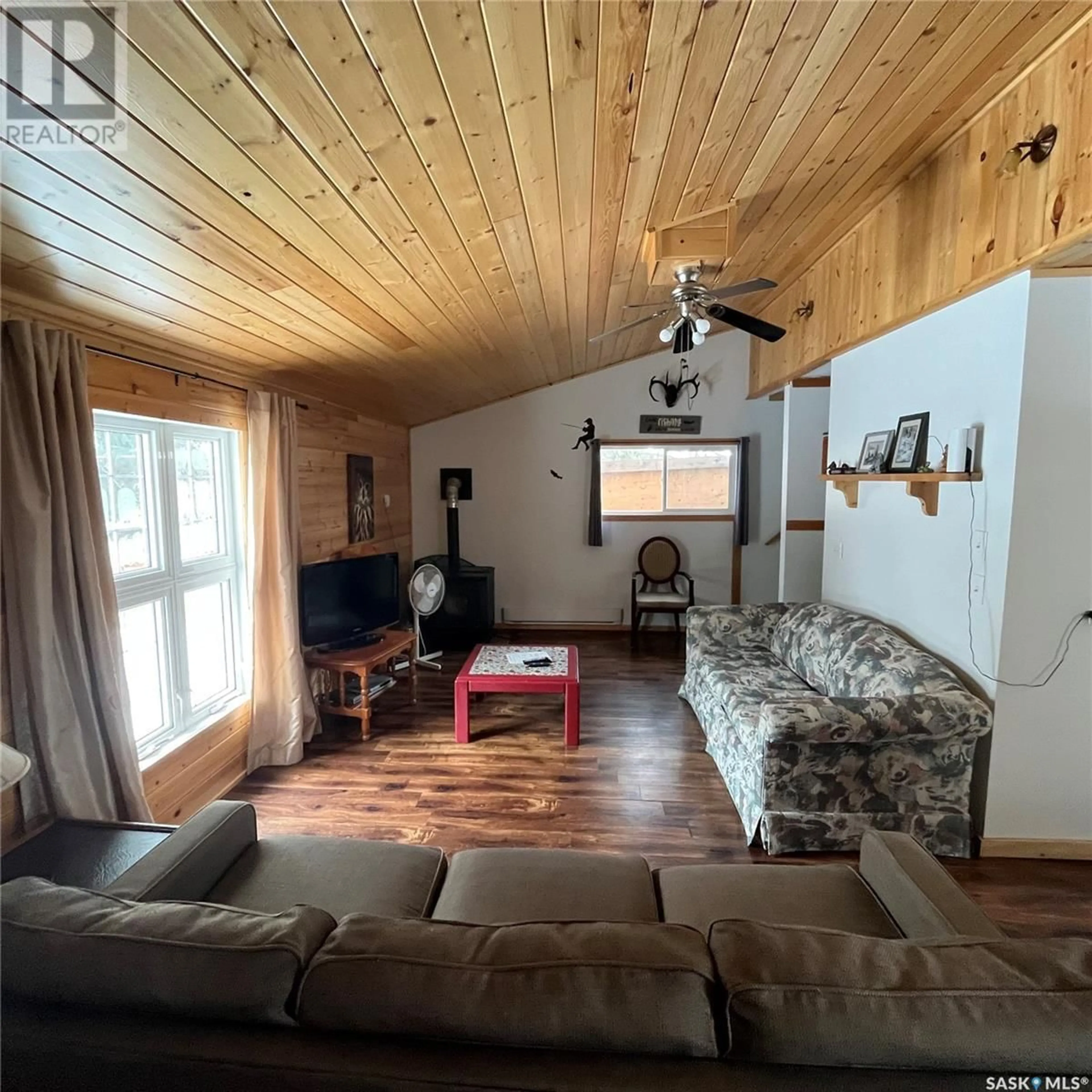 Living room with furniture, wood/laminate floor for 212 RICHARD DRIVE, Barrier Valley Rm No. 397 Saskatchewan S0E0B0