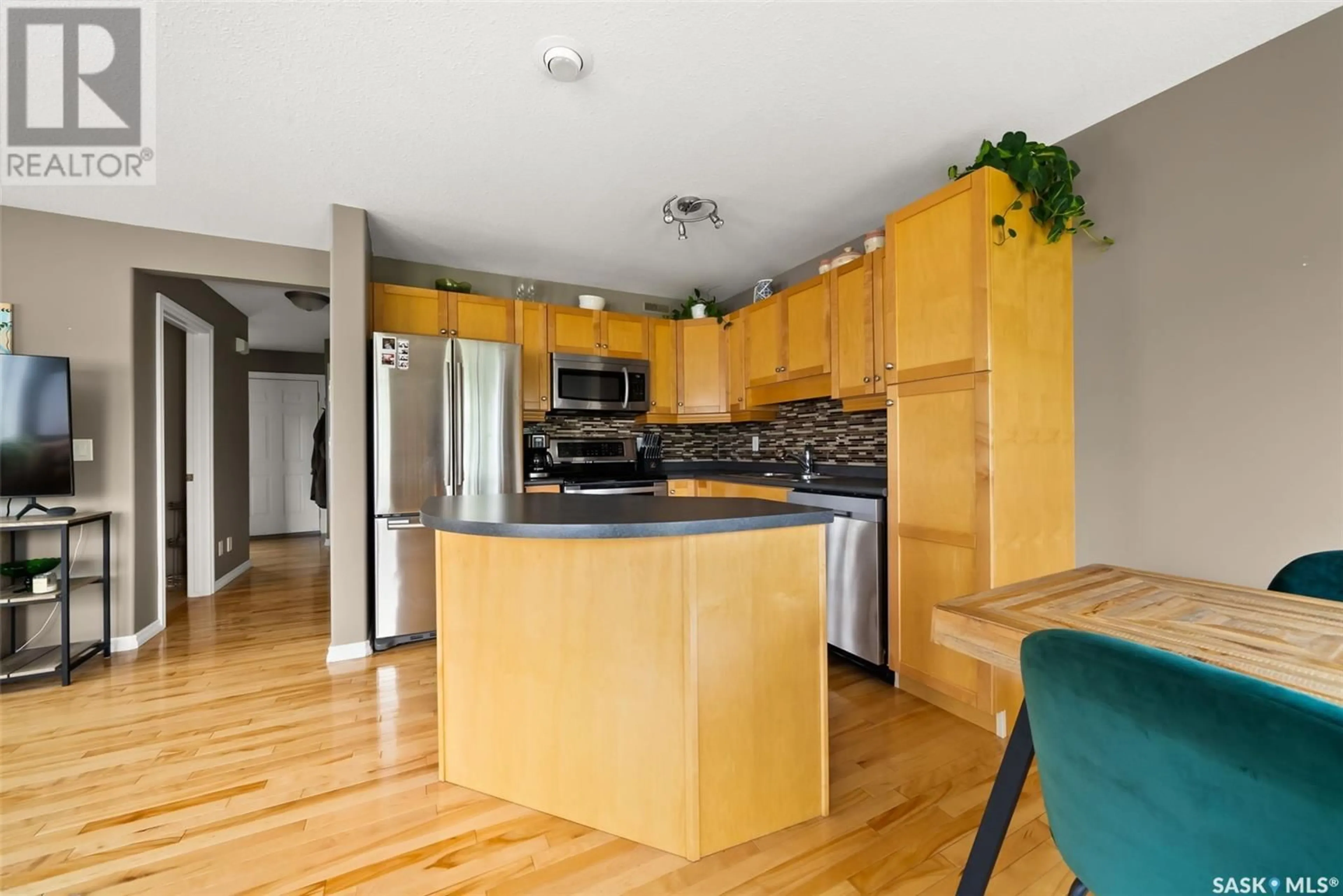 Open concept kitchen, wood/laminate floor for 35 2400 TELL PLACE, Regina Saskatchewan S4V3E3