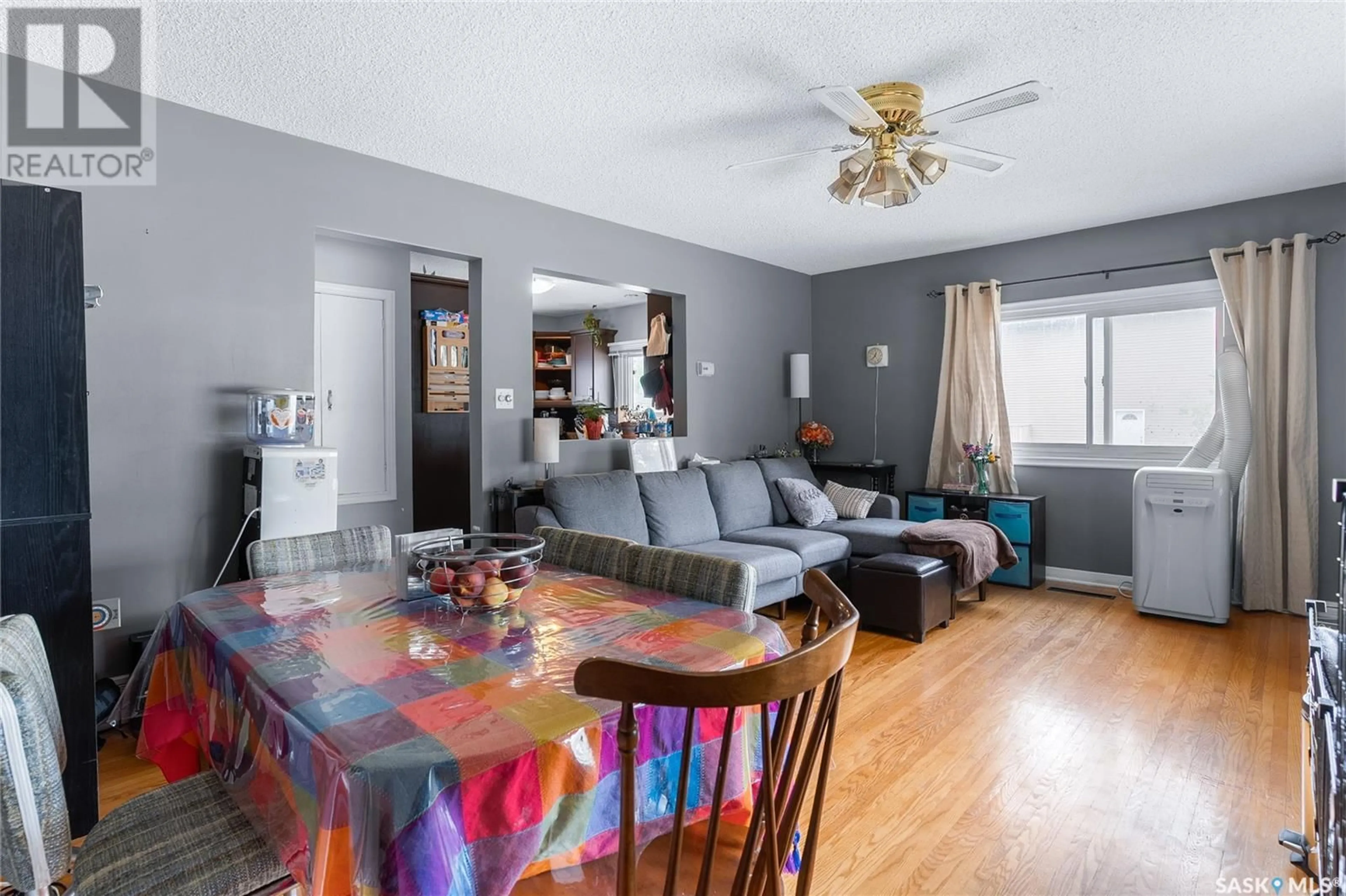 Living room with furniture, wood/laminate floor for 1201 M AVENUE, Saskatoon Saskatchewan S7M2M3
