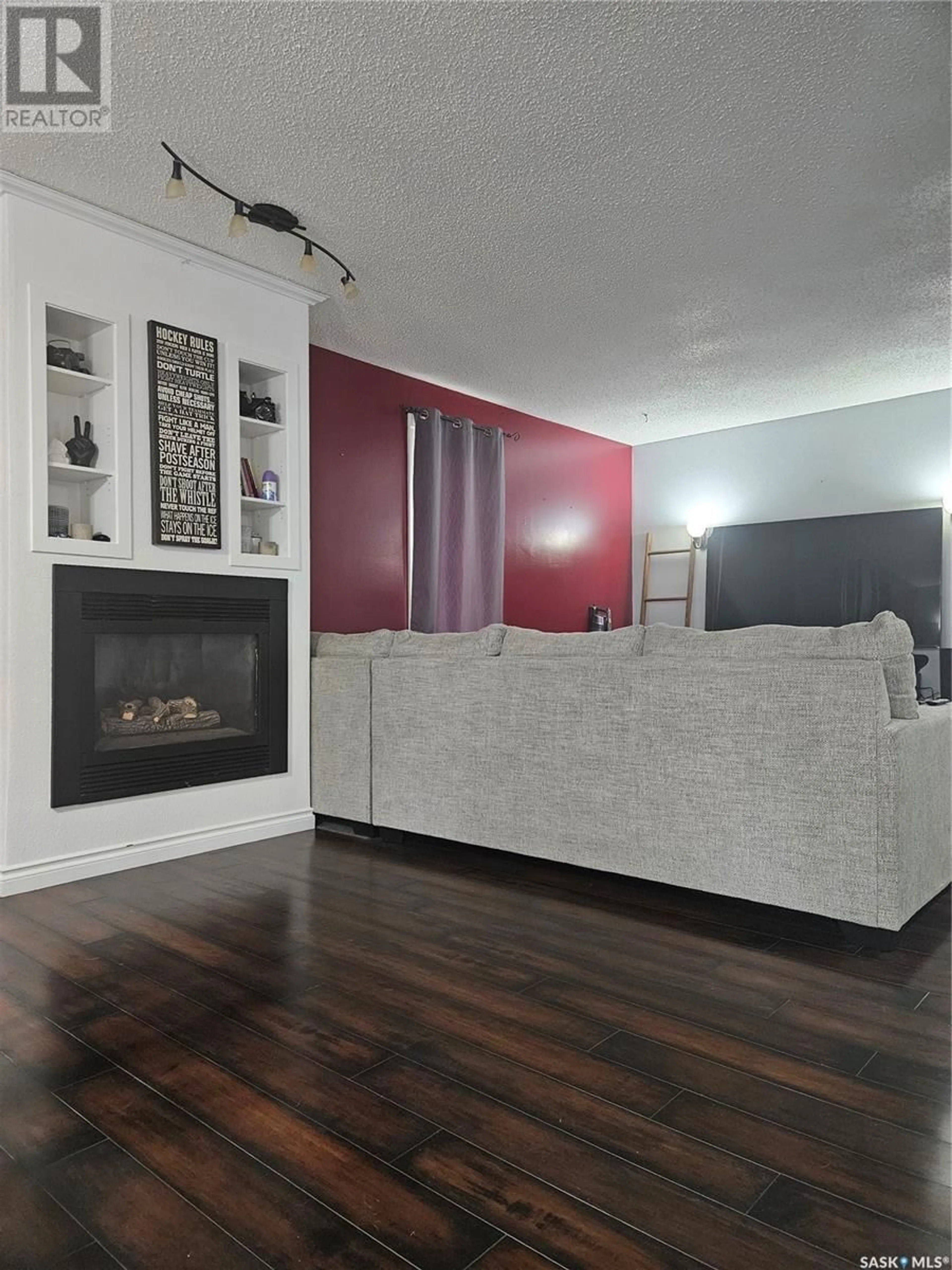 Living room with furniture, wood/laminate floor for 526 RUPERT CRESCENT, Codette Saskatchewan S0E0P0