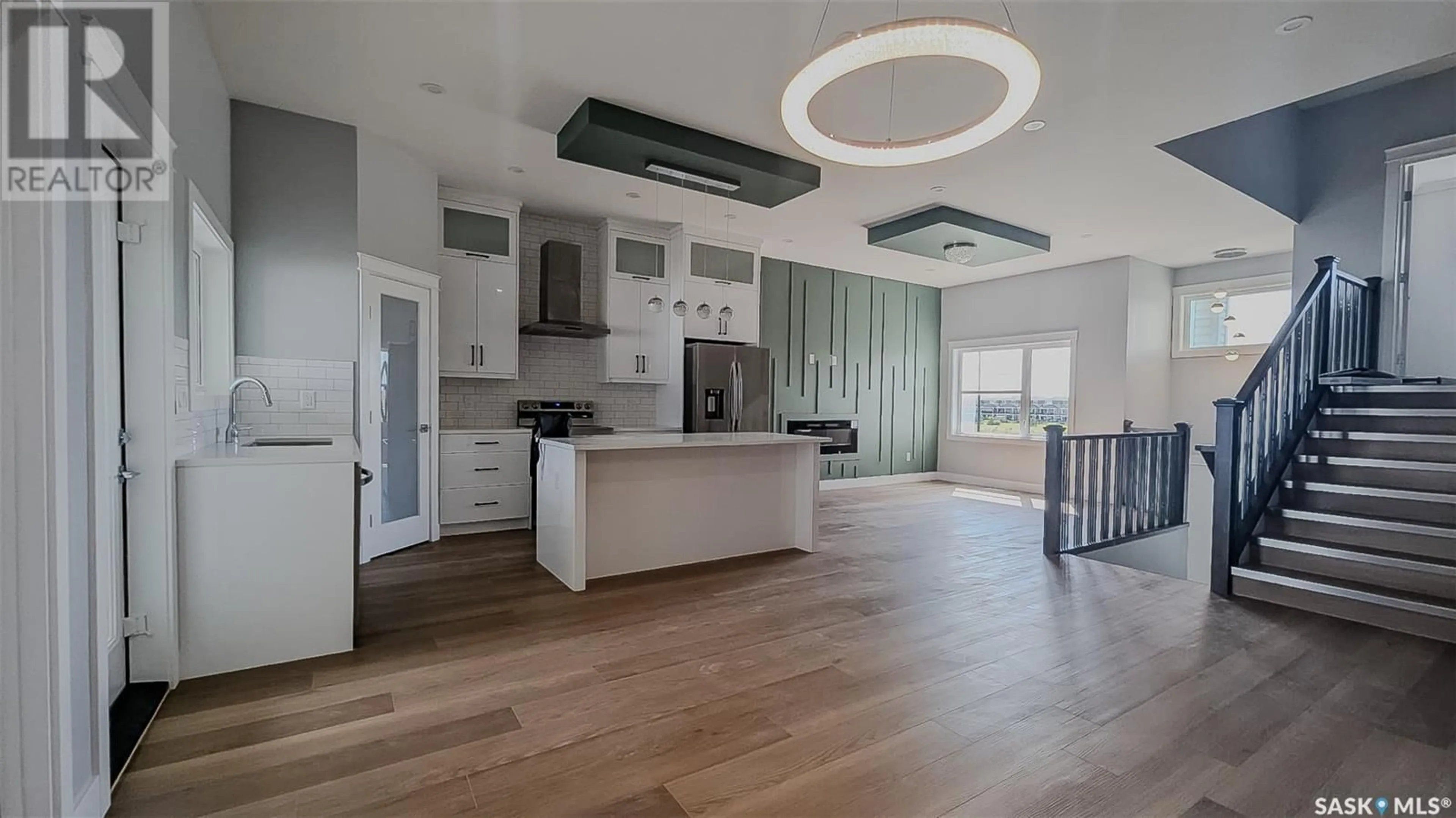 Open concept kitchen, wood/laminate floor for 171 MCARTHUR LANE, Saskatoon Saskatchewan S7L6Y3