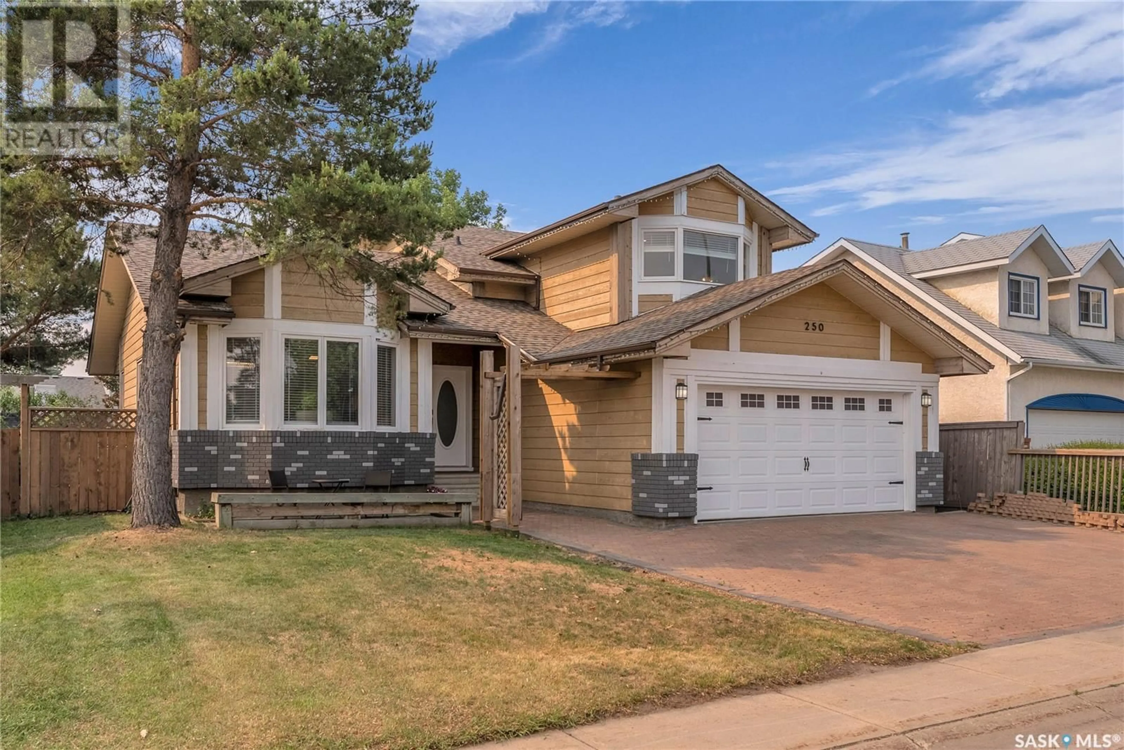 Home with vinyl exterior material, street for 250 EMMELINE ROAD, Saskatoon Saskatchewan S7J5B7