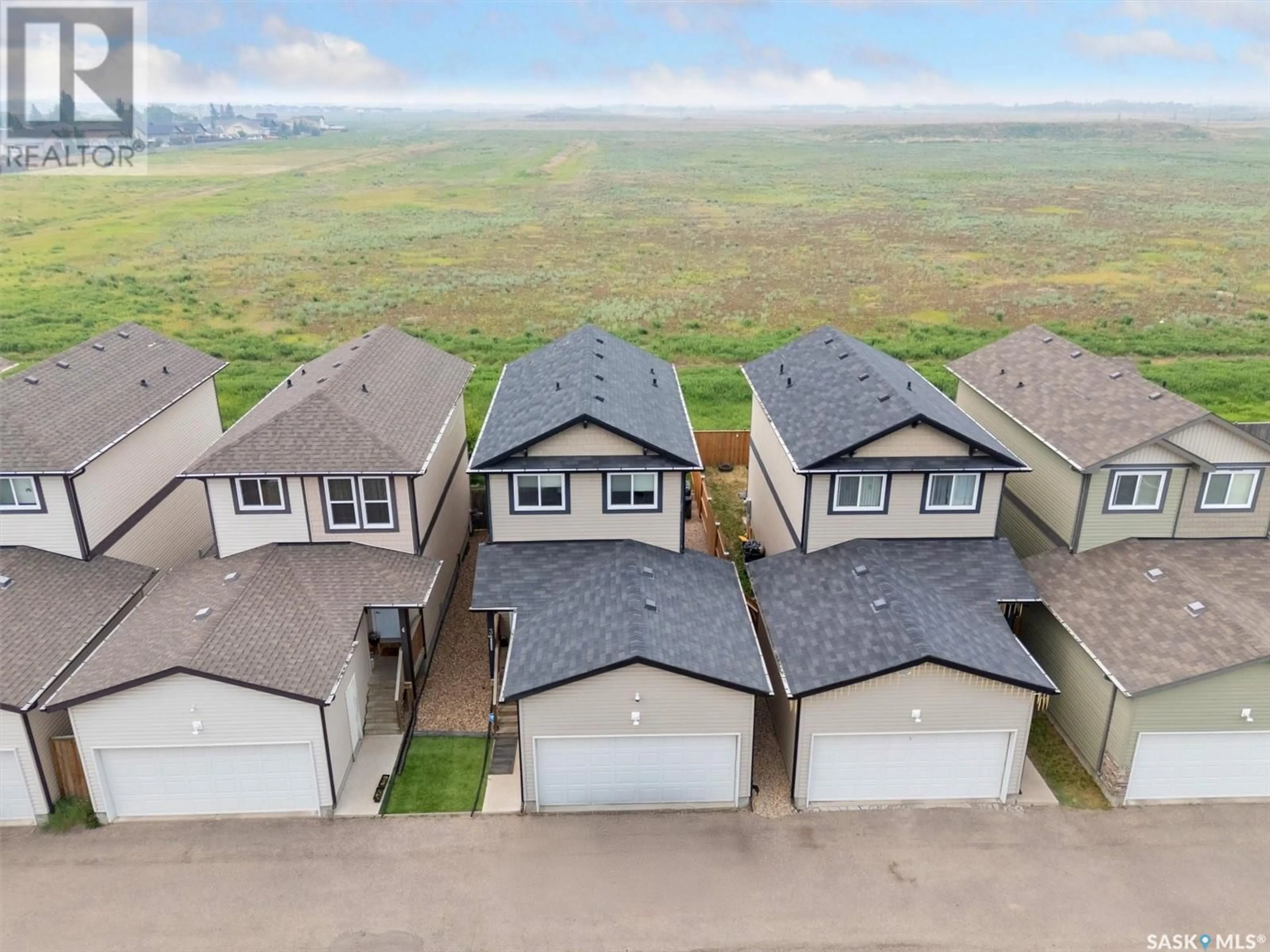 A pic from outside/outdoor area/front of a property/back of a property/a pic from drone, unknown for 207 - 3 MCCALLUM WAY, Saskatoon Saskatchewan S7L0A1