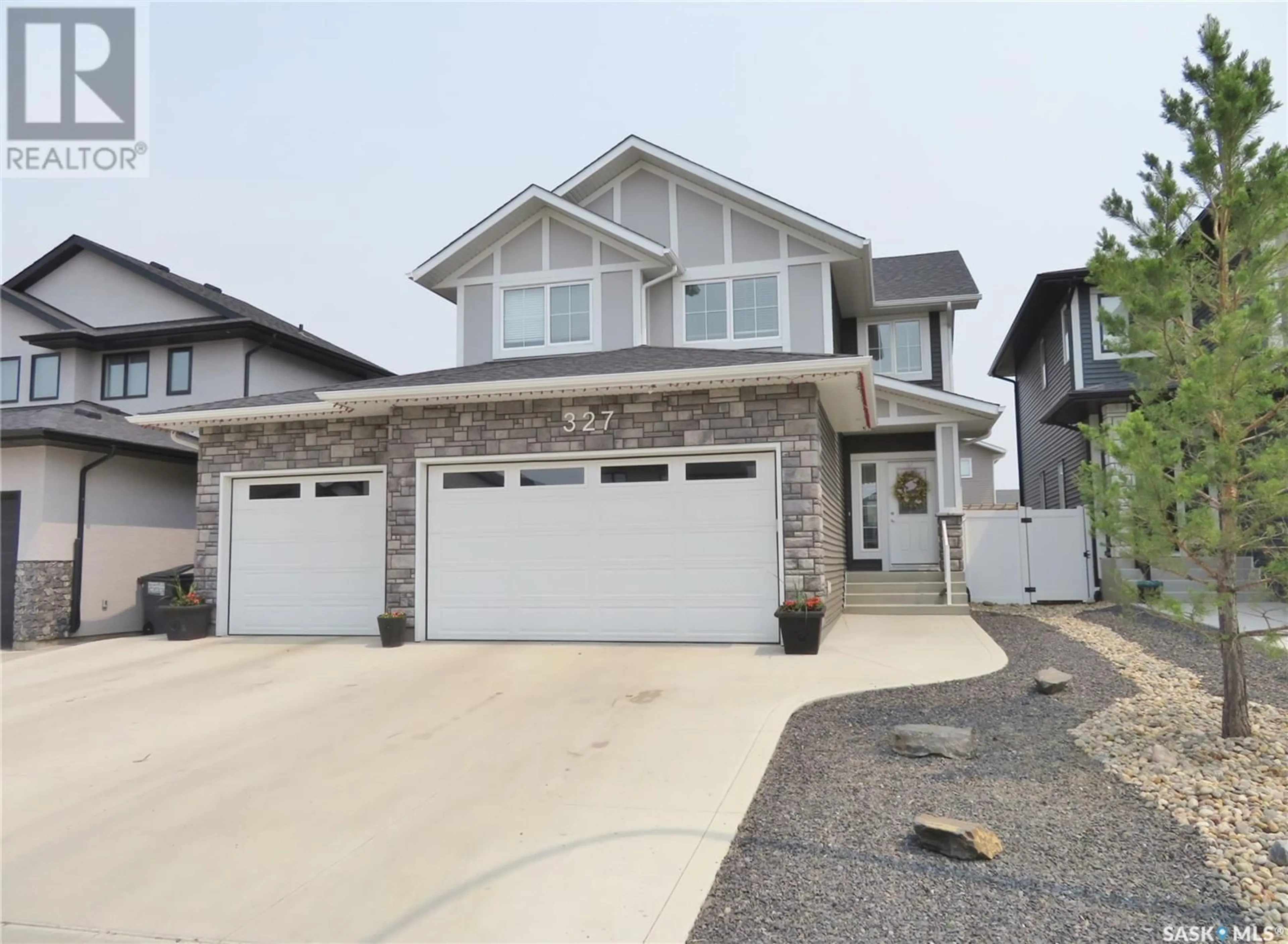Home with vinyl exterior material, street for 327 HAMM WAY, Saskatoon Saskatchewan S7V0W3