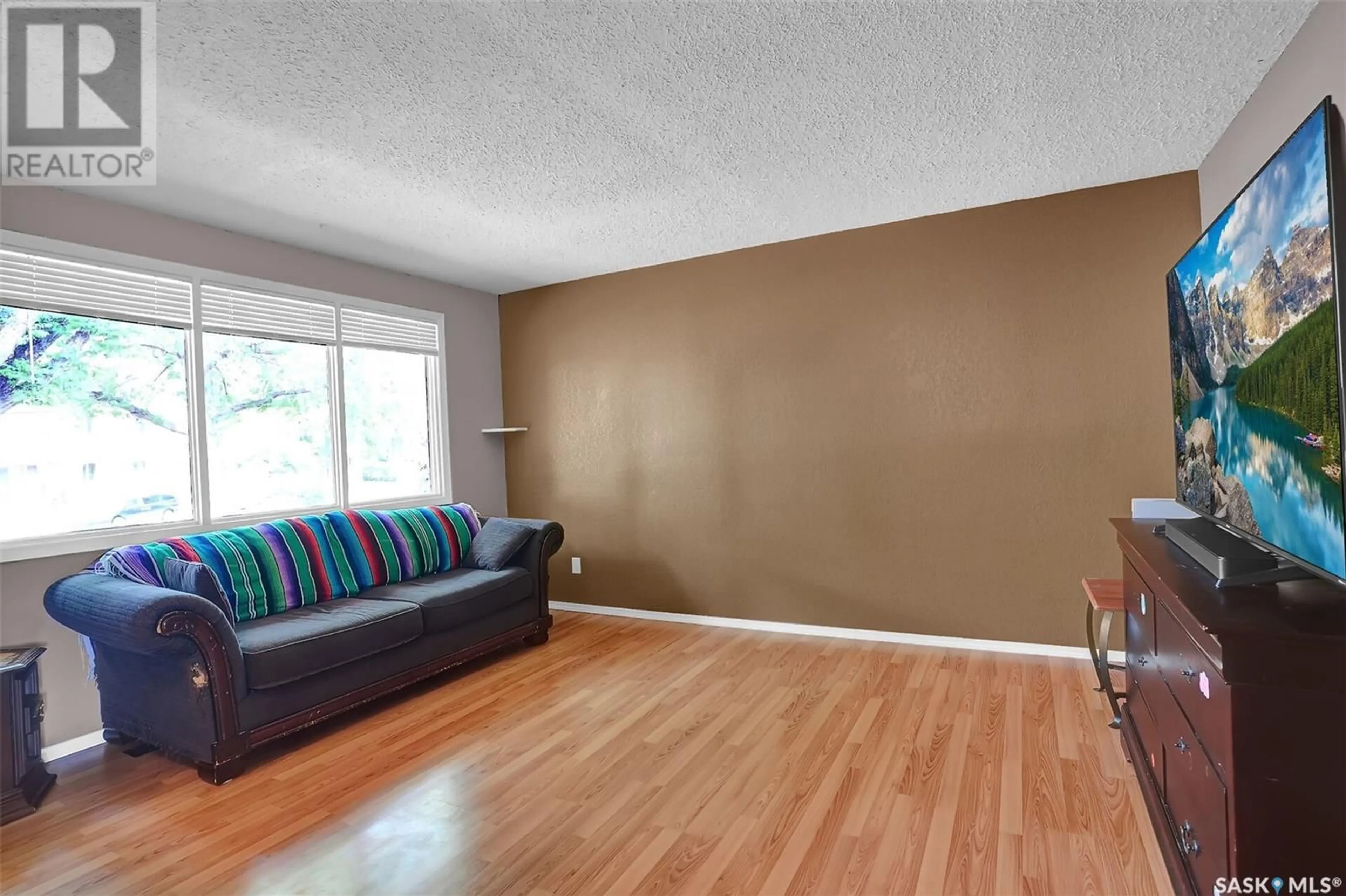 Living room with furniture, wood/laminate floor for 26 FORSYTH CRESCENT, Regina Saskatchewan S4R5L7