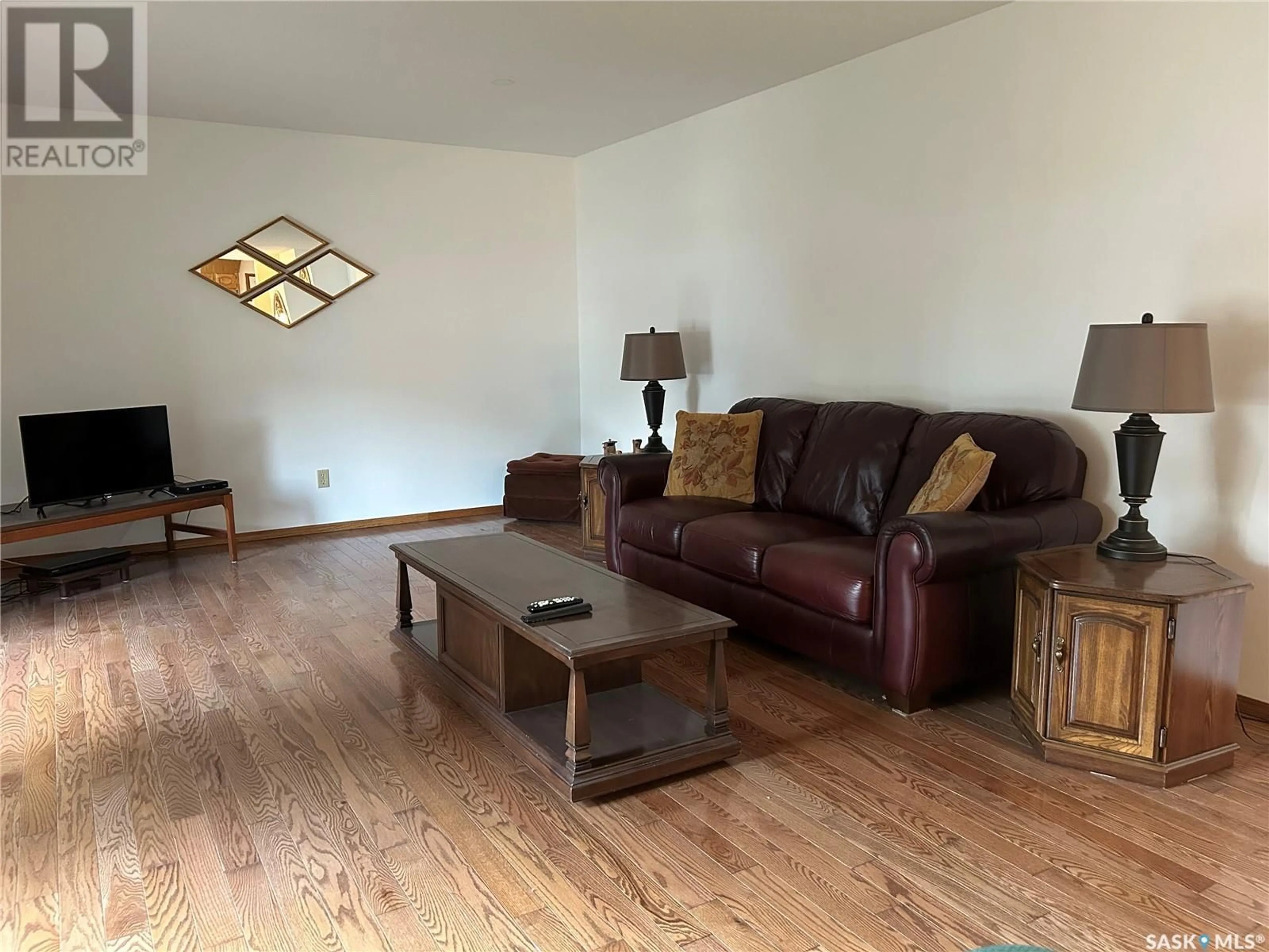 Living room with furniture, wood/laminate floor for 1563 WAHLMEIER DRIVE, Estevan Saskatchewan S4A2M1