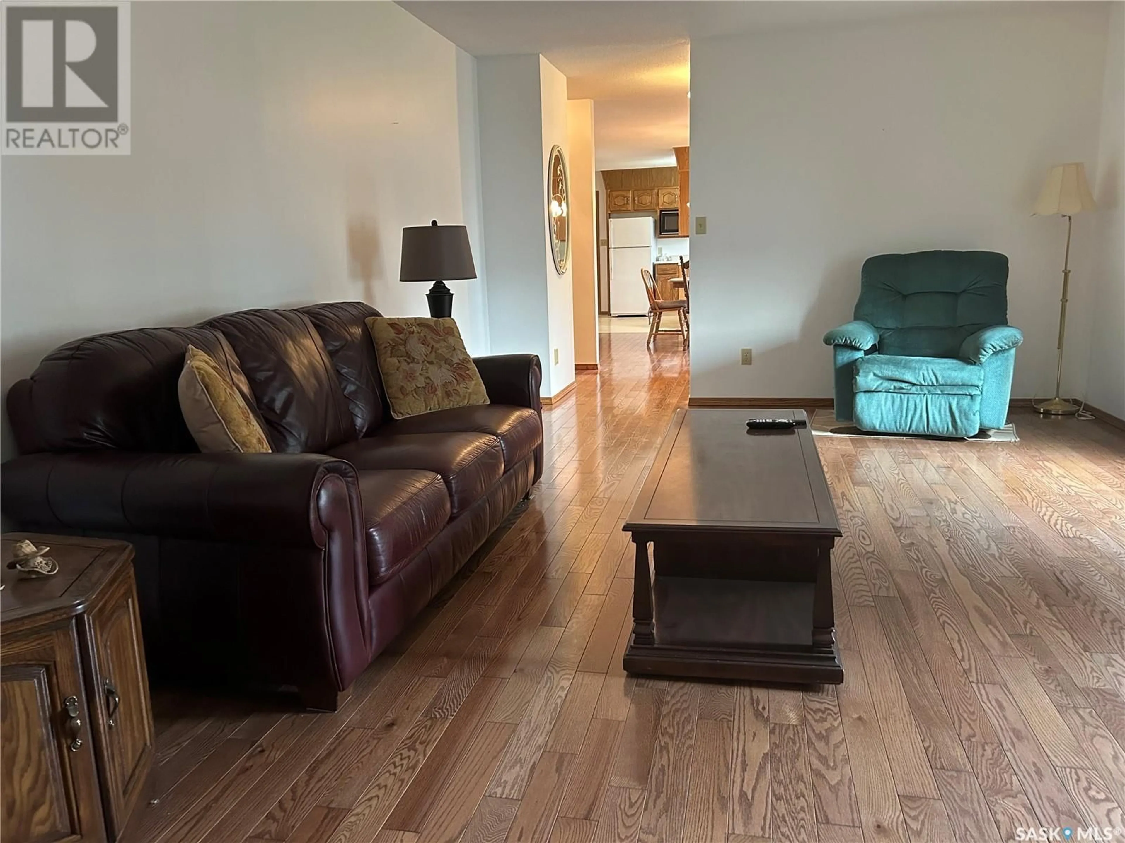 Living room with furniture, wood/laminate floor for 1563 WAHLMEIER DRIVE, Estevan Saskatchewan S4A2M1