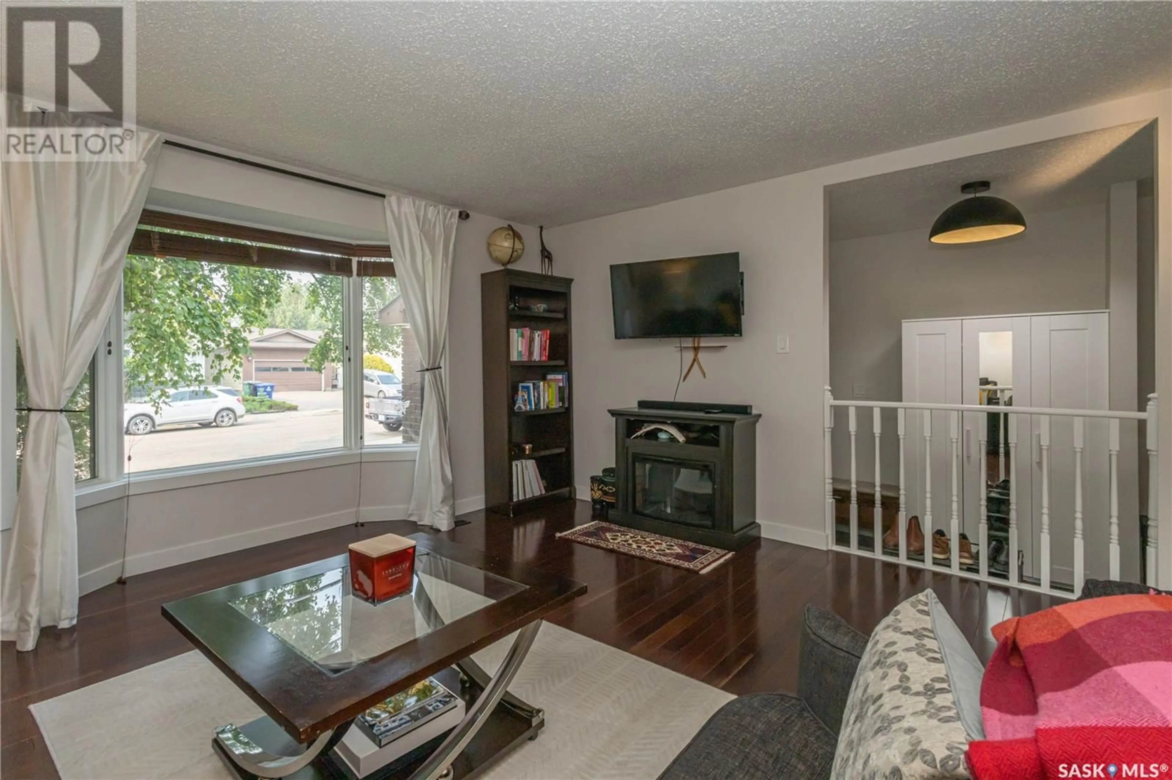 Living room with furniture, wood/laminate floor for 370 MARCOTTE CRESCENT, Saskatoon Saskatchewan S7K7N8