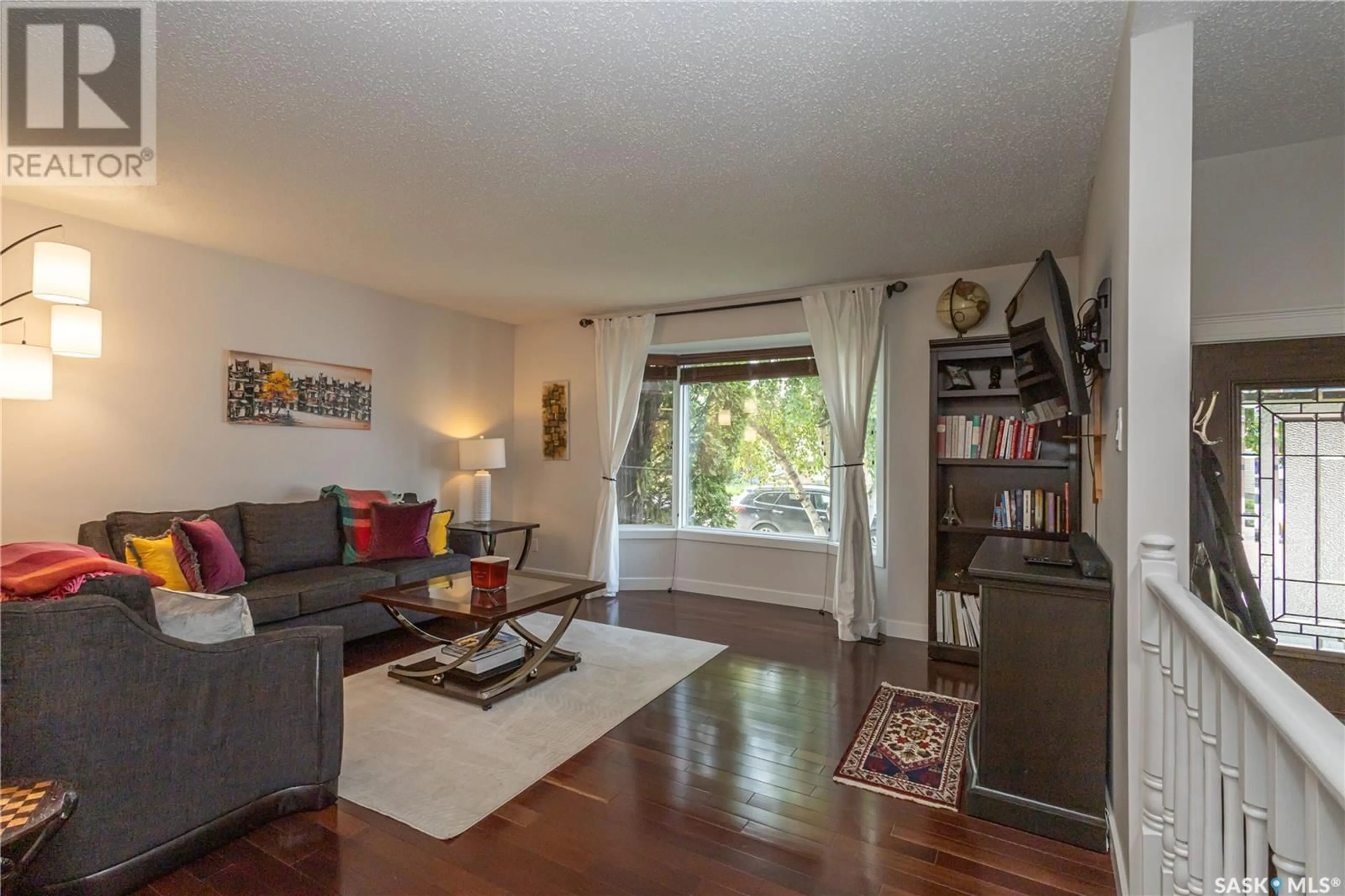 Living room with furniture, wood/laminate floor for 370 MARCOTTE CRESCENT, Saskatoon Saskatchewan S7K7N8