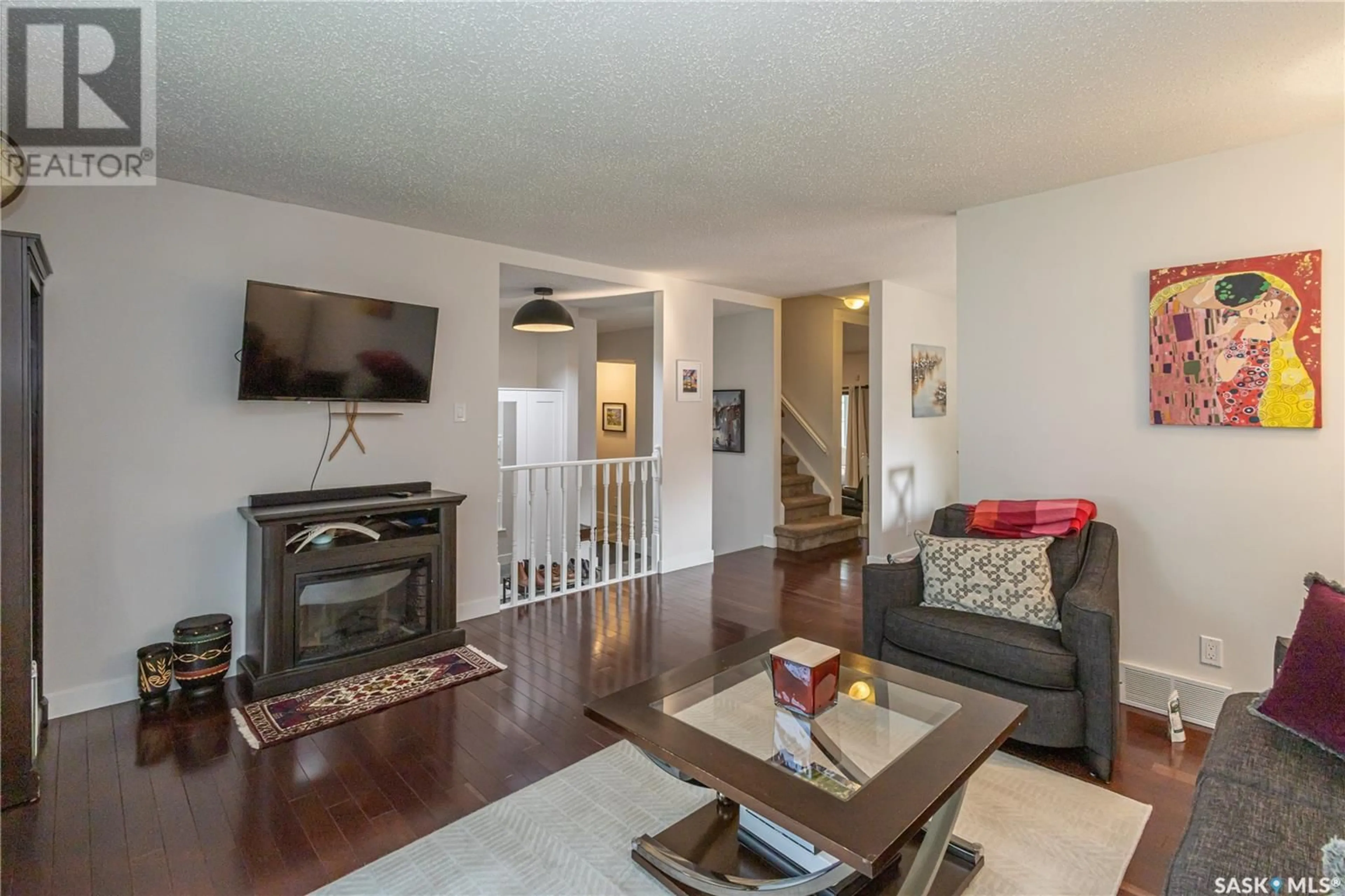 Living room with furniture, wood/laminate floor for 370 MARCOTTE CRESCENT, Saskatoon Saskatchewan S7K7N8