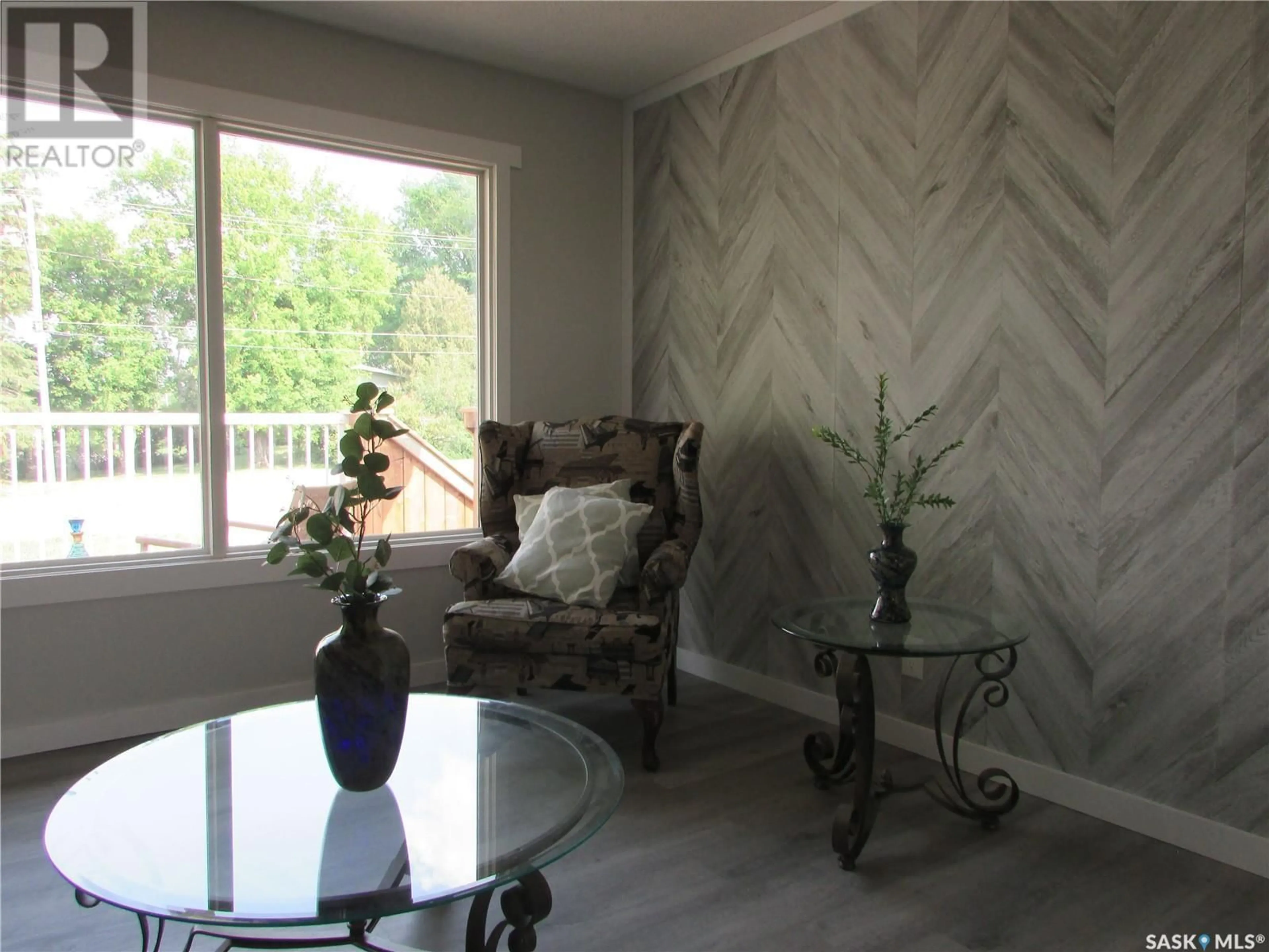 Living room with furniture, wood/laminate floor for 11 WILSON STREET, Birch Hills Saskatchewan S0J0G0