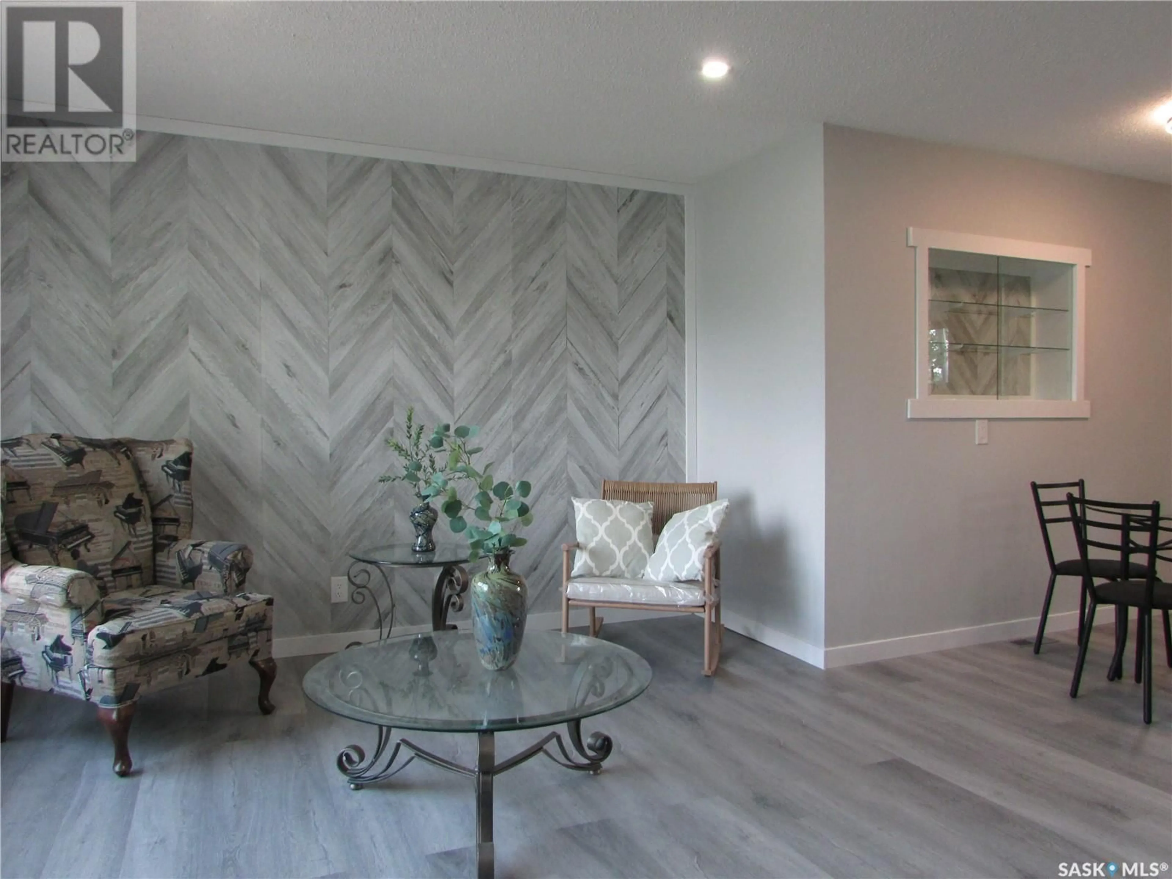 Living room with furniture, wood/laminate floor for 11 WILSON STREET, Birch Hills Saskatchewan S0J0G0