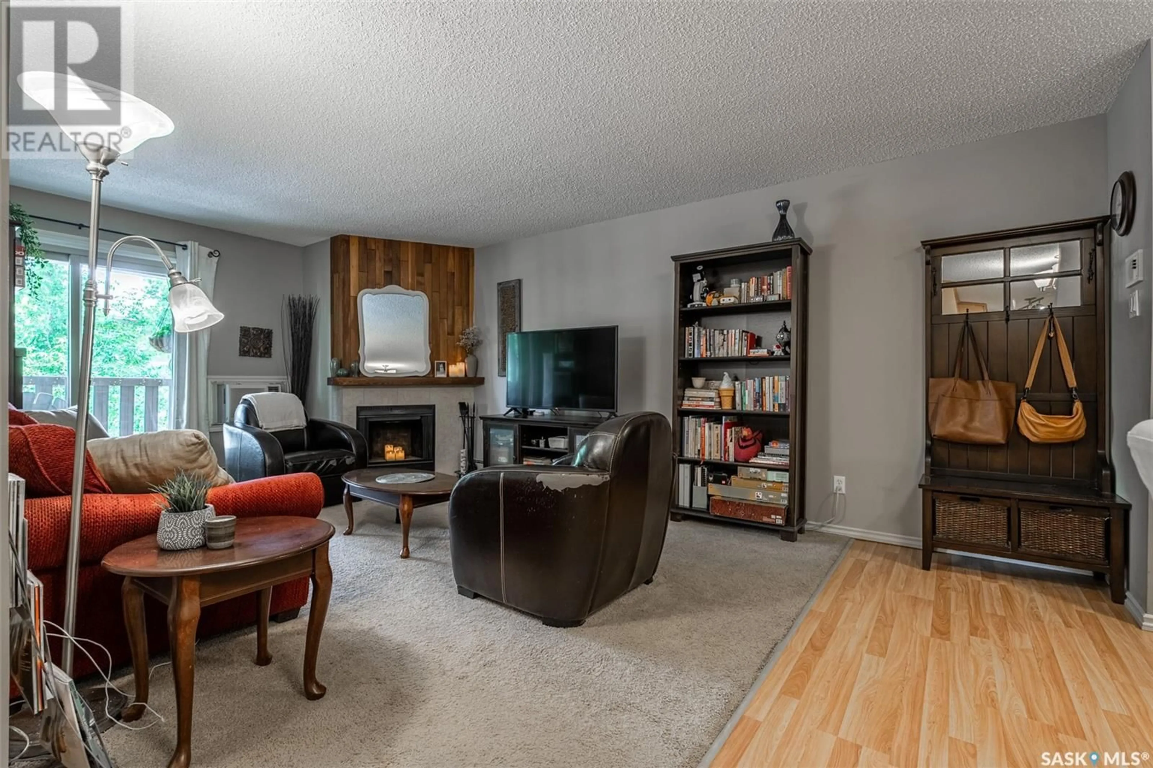 Living room with furniture, wood/laminate floor for 204B - 1121 MCKERCHER DRIVE, Saskatoon Saskatchewan S7H5B8