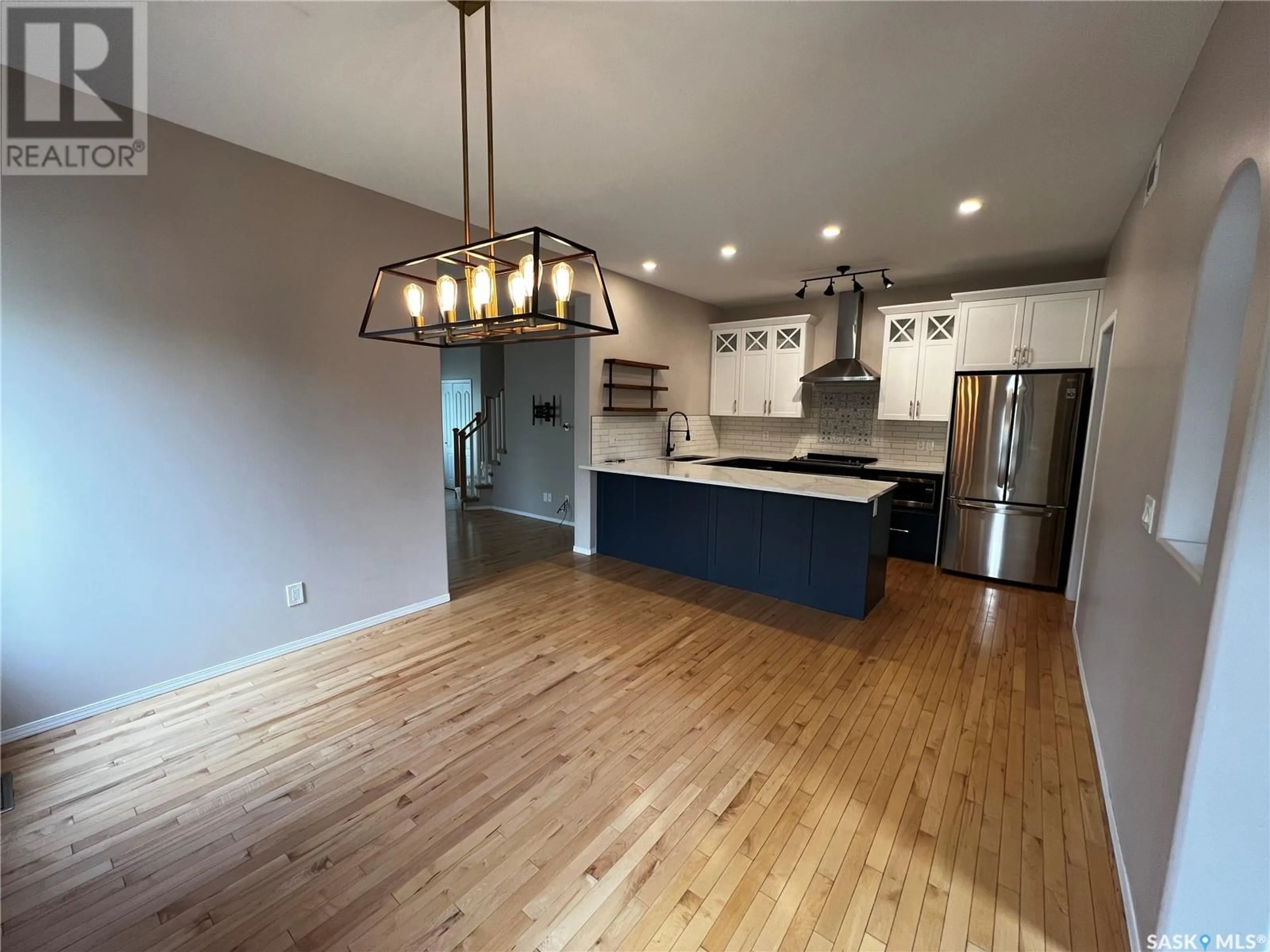 Open concept kitchen, wood/laminate floor for 202 2ND STREET, Saskatoon Saskatchewan S7H1N6