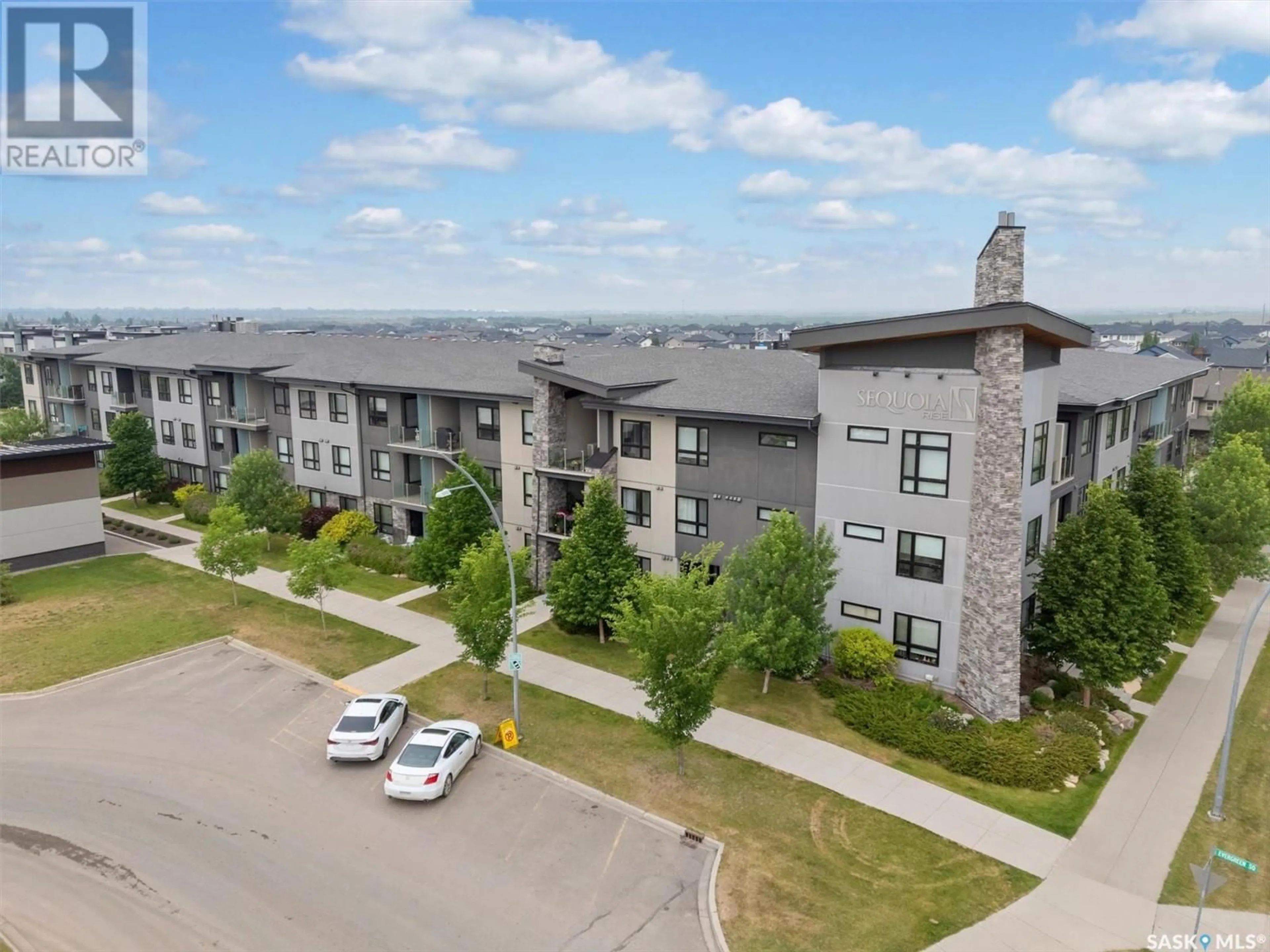 A pic from outside/outdoor area/front of a property/back of a property/a pic from drone, mountain view for 216 235 EVERGREEN SQUARE, Saskatoon Saskatchewan S7W0T9