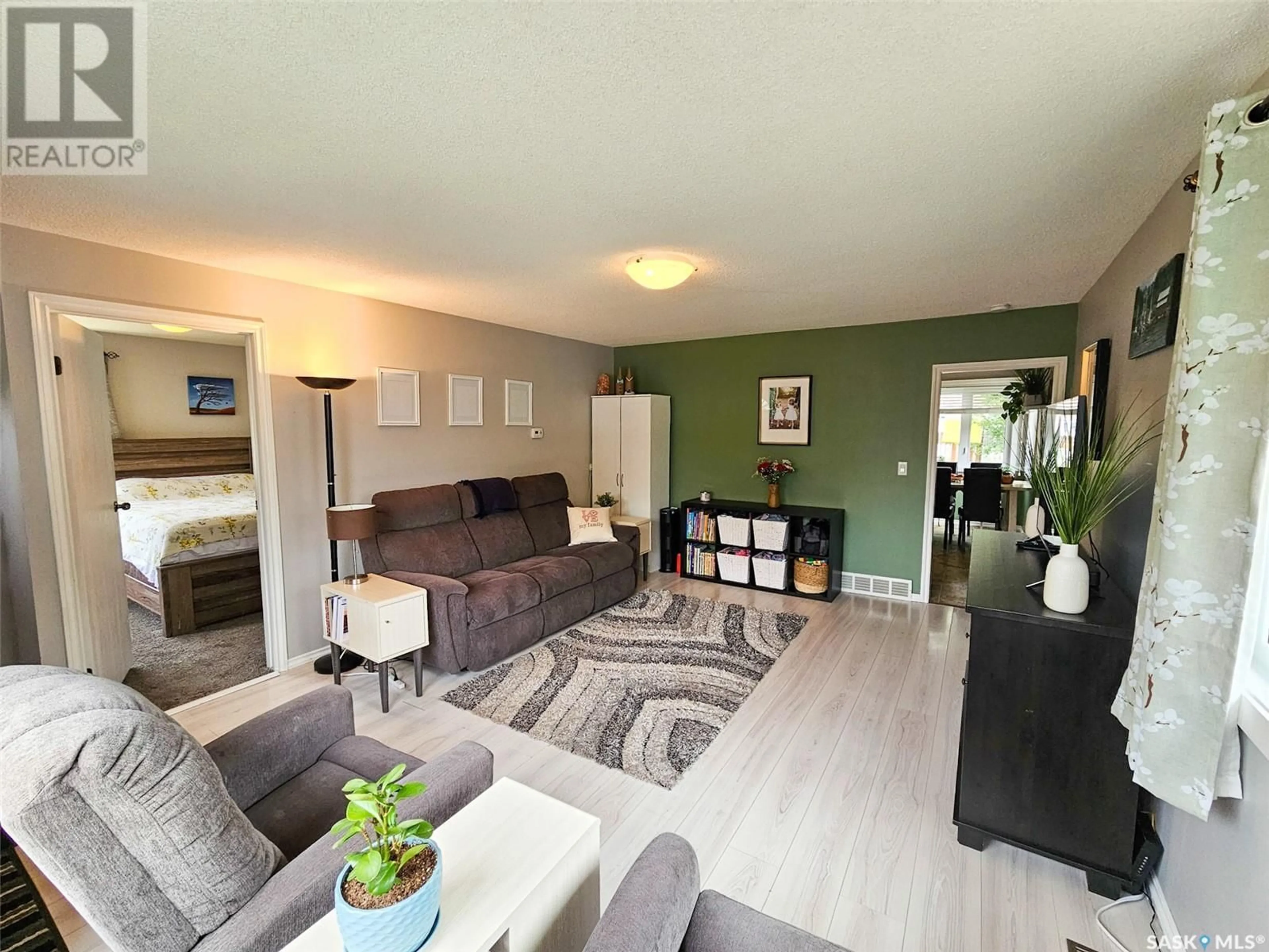 Living room with furniture, wood/laminate floor for 267 5TH AVENUE, Swift Current Saskatchewan S9H3M9