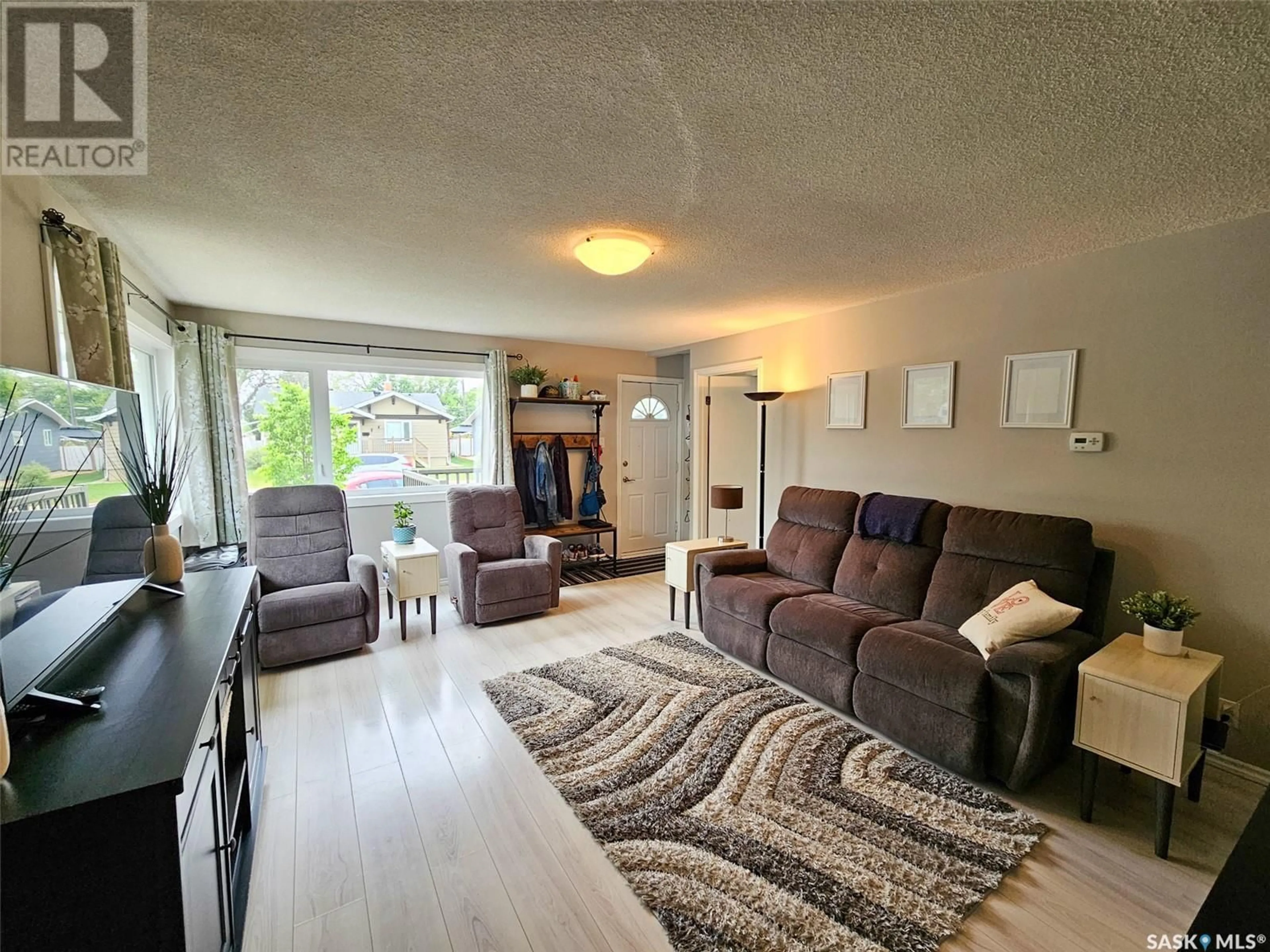 Living room with furniture, wood/laminate floor for 267 5TH AVENUE, Swift Current Saskatchewan S9H3M9