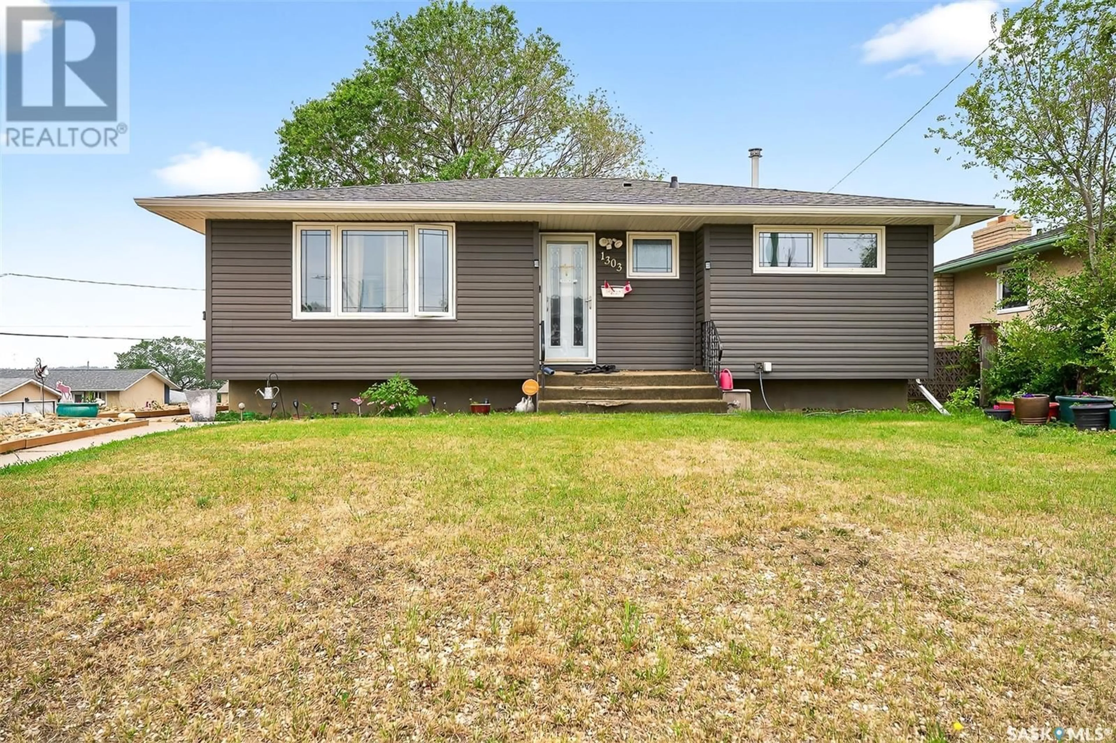 Home with vinyl exterior material, street for 1303 ATHABASCA STREET, Moose Jaw Saskatchewan S6H6C8