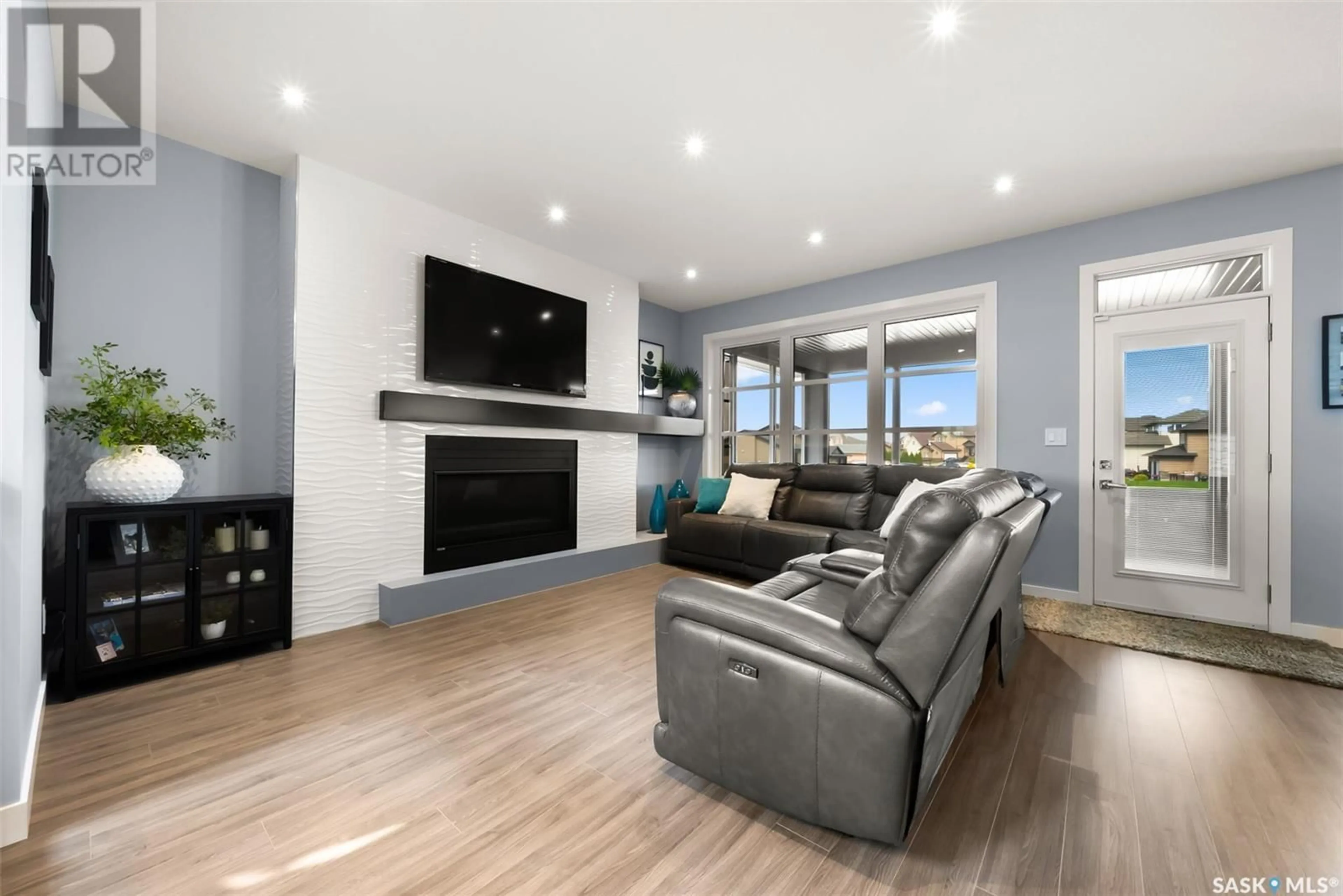 Living room with furniture, wood/laminate floor for 2 MCKENZIE LANDING, White City Saskatchewan S4L0B2