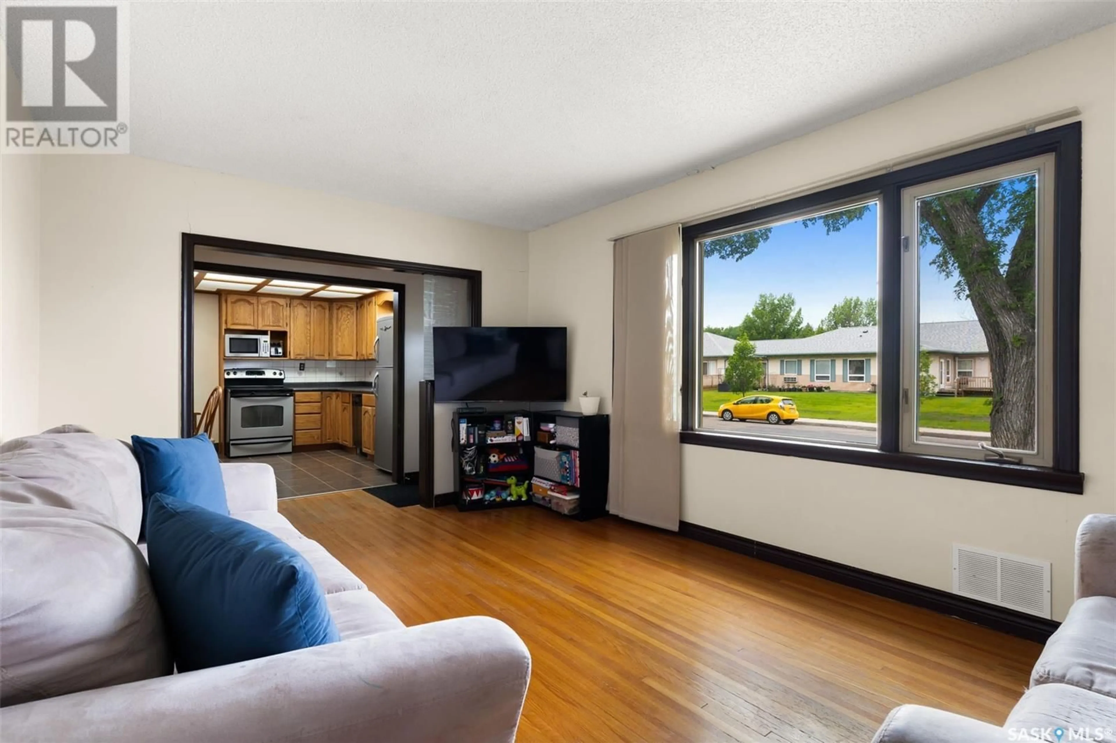 Living room with furniture, wood/laminate floor for 1345 ROYAL STREET, Regina Saskatchewan S4T5A2