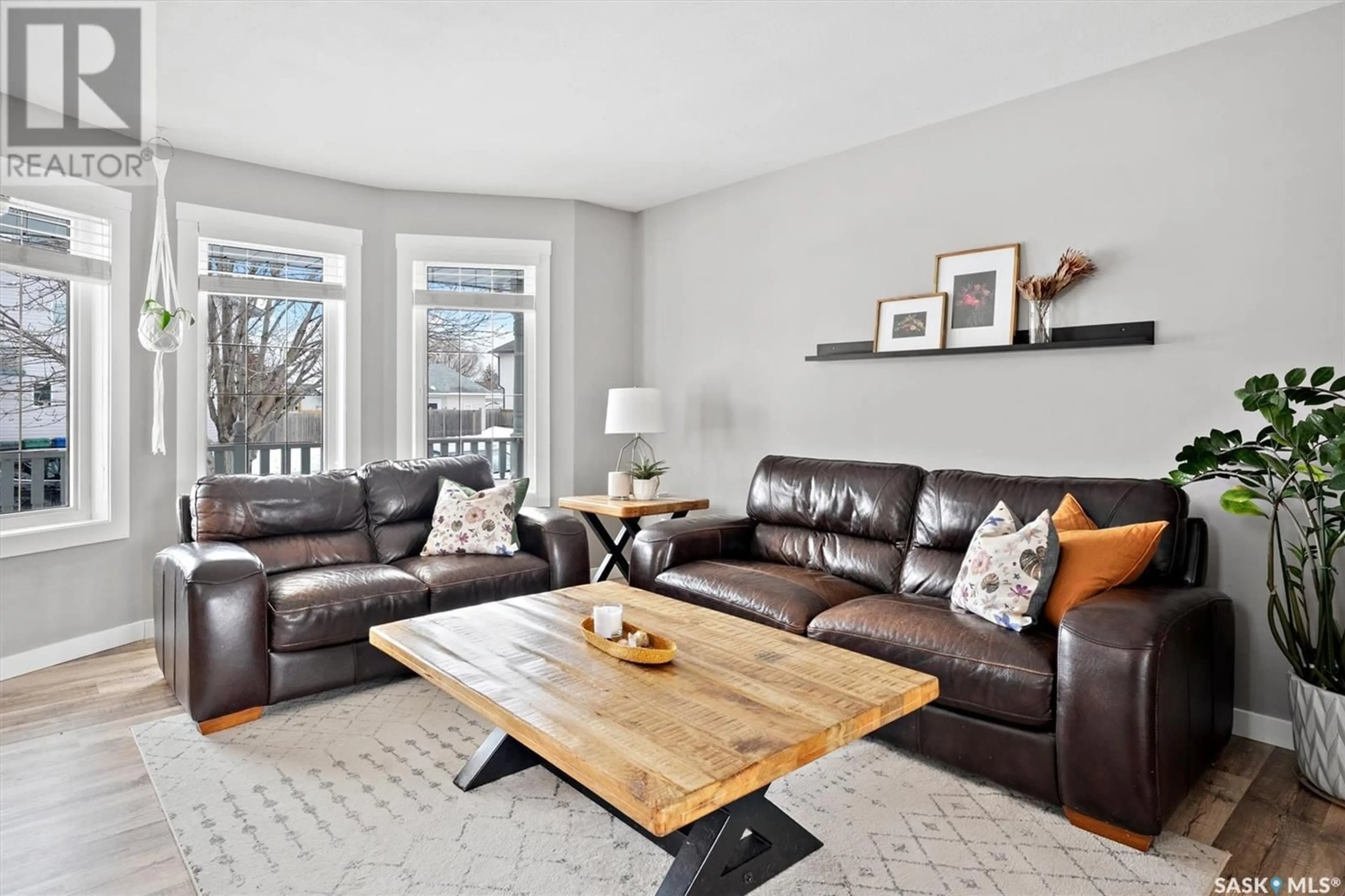 Living room with furniture, wood/laminate floor for 555 CARTER WAY, Saskatoon Saskatchewan S7L7K5