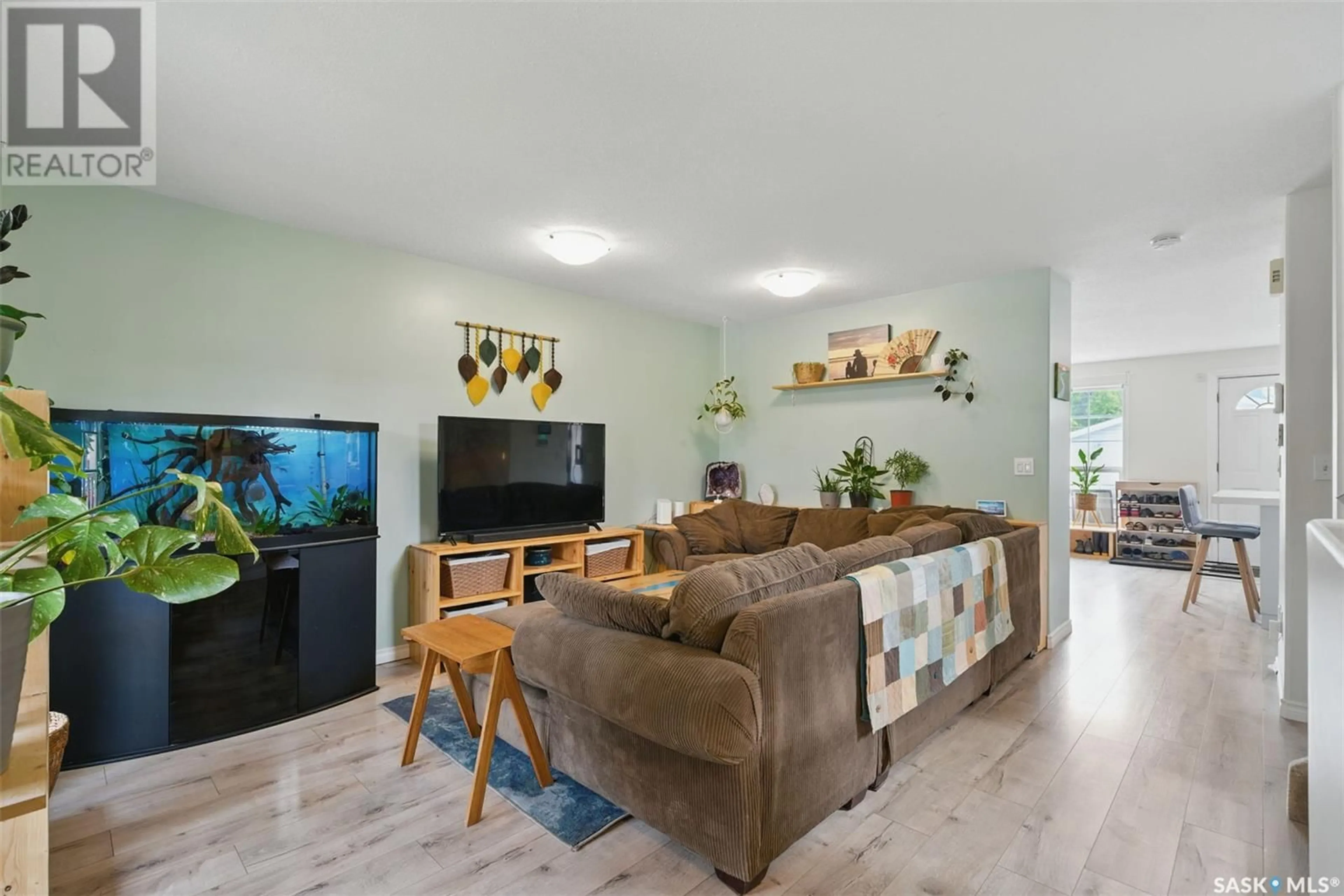 Living room with furniture, wood/laminate floor for 1400 6TH AVENUE, Saskatoon Saskatchewan S7K2T8