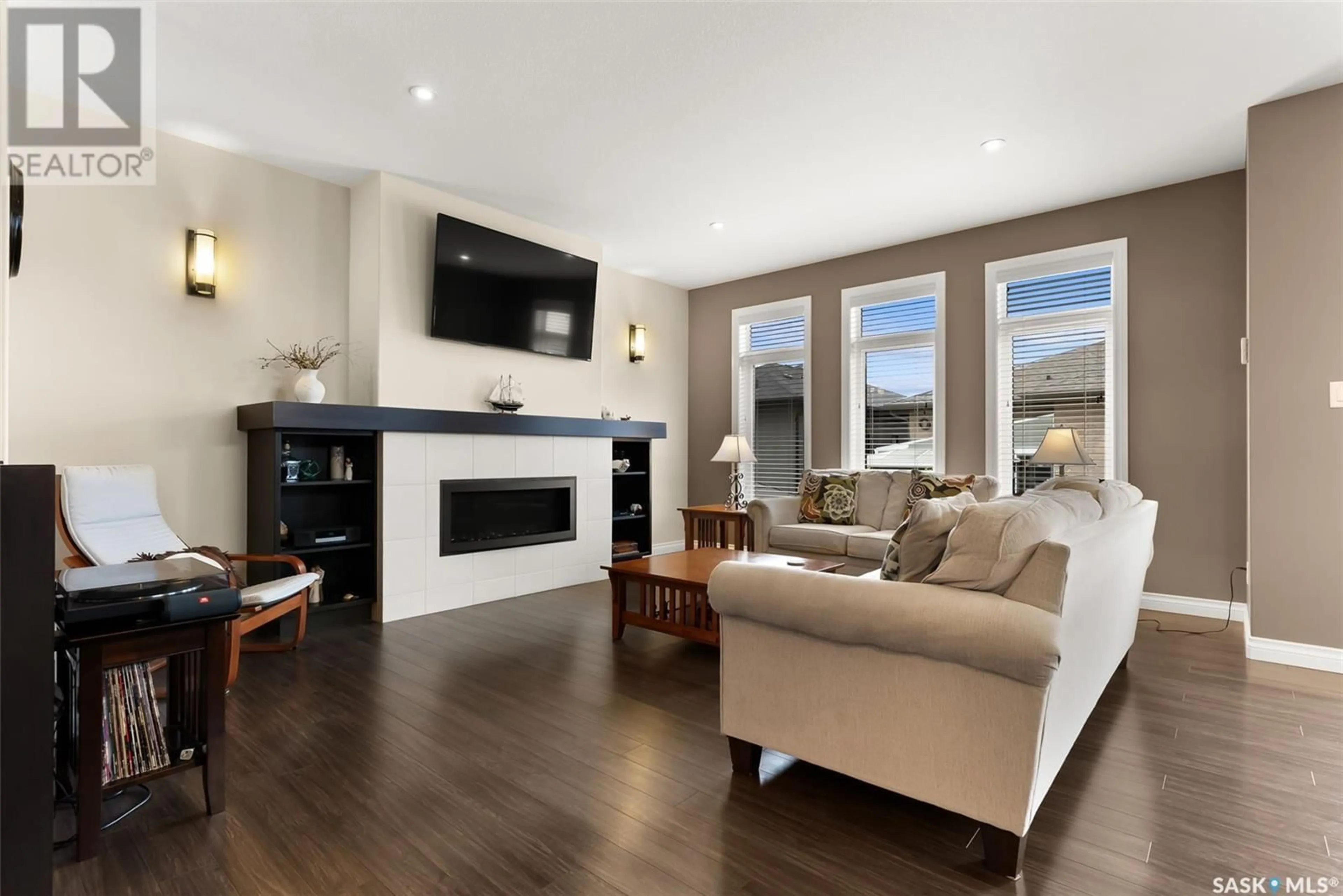 Living room with furniture, wood/laminate floor for 3326 GREEN BROOK ROAD, Regina Saskatchewan S4V3K2