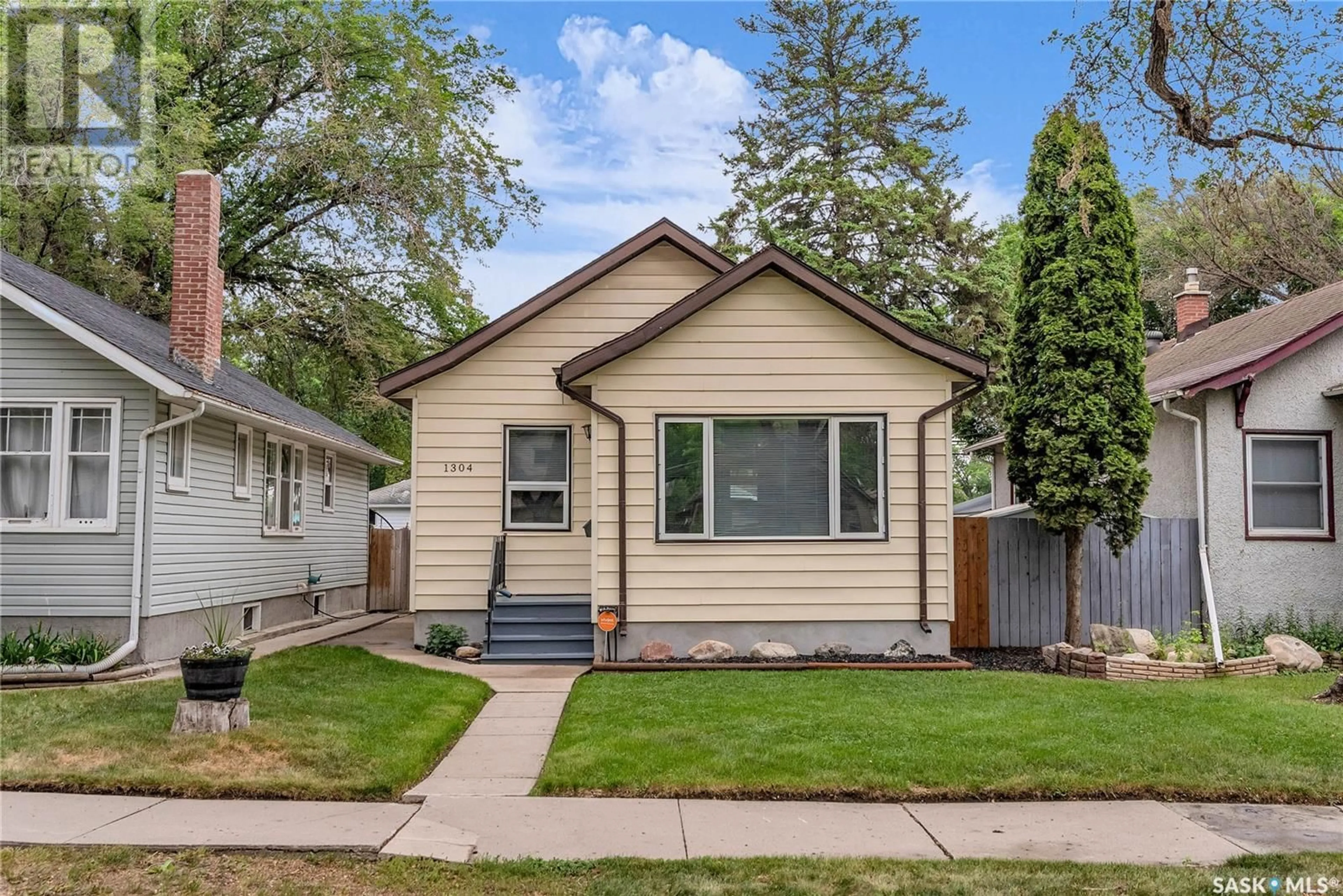Home with vinyl exterior material, street for 1304 C AVENUE, Saskatoon Saskatchewan S7L1K8