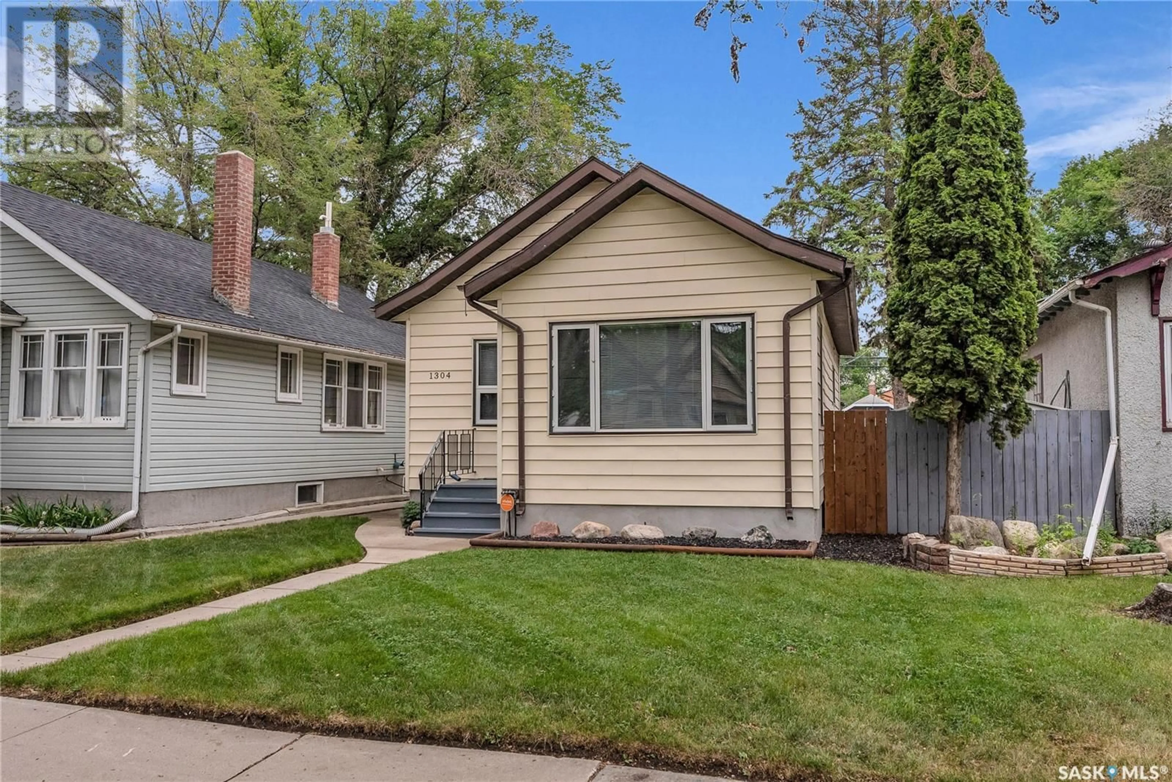 Home with vinyl exterior material, street for 1304 C AVENUE, Saskatoon Saskatchewan S7L1K8