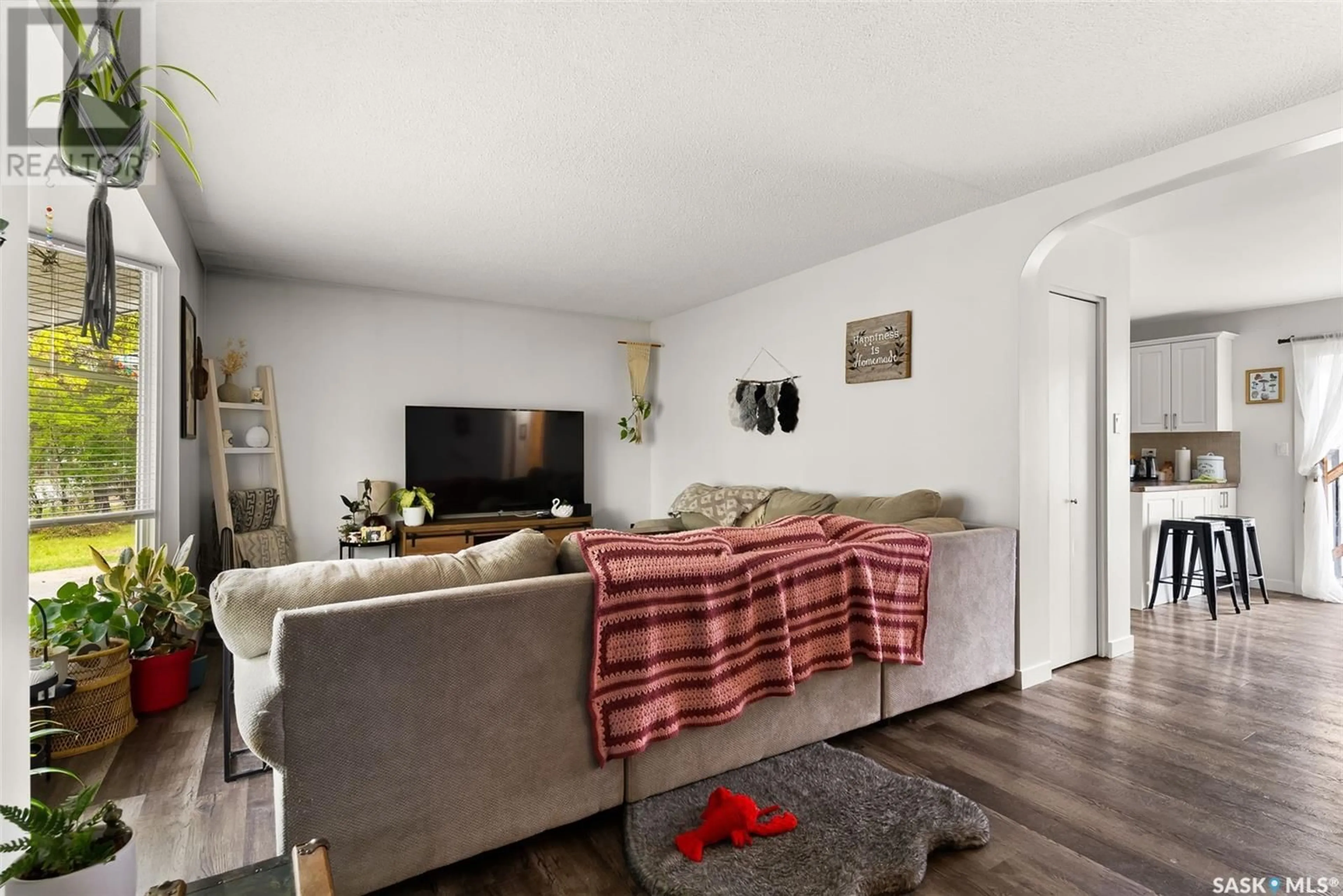 Living room with furniture, wood/laminate floor for 11 KANGLES STREET, Regina Saskatchewan S4N4M9