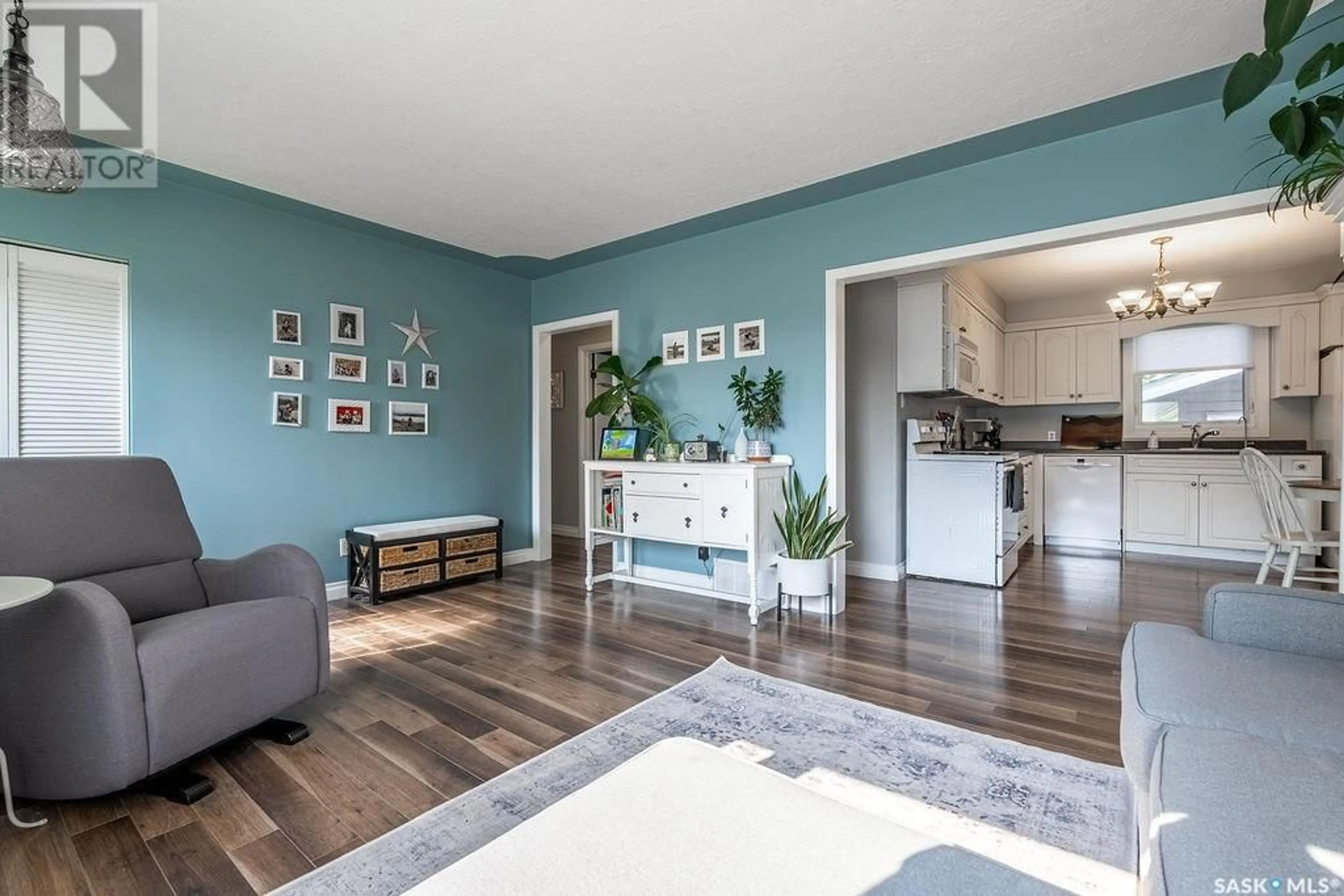 Living room with furniture, wood/laminate floor for 2236 EWART AVENUE, Saskatoon Saskatchewan S7J1Y2