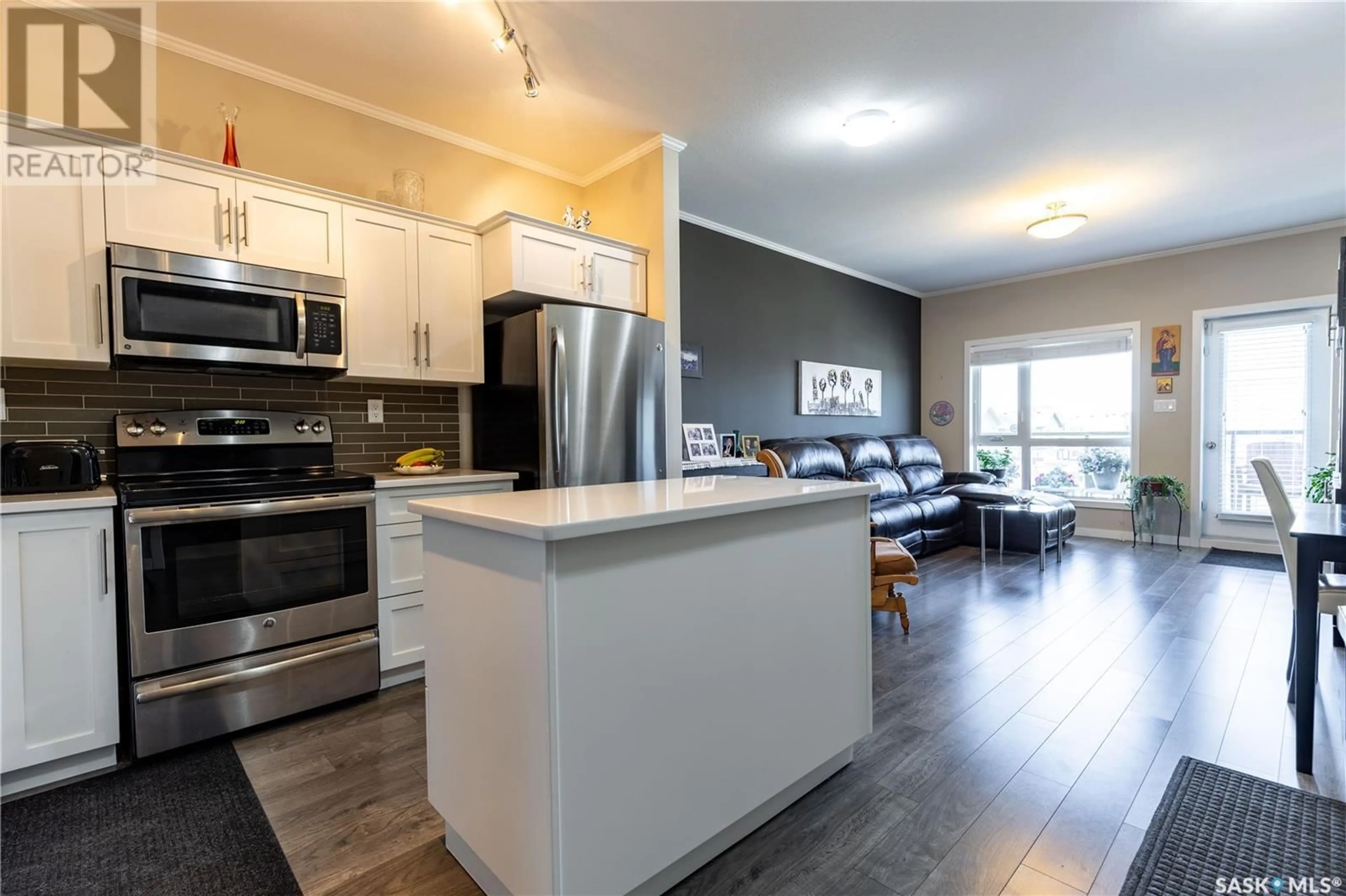 Open concept kitchen, wood/laminate floor for 215 545 HASSARD CLOSE, Saskatoon Saskatchewan S7L6V3