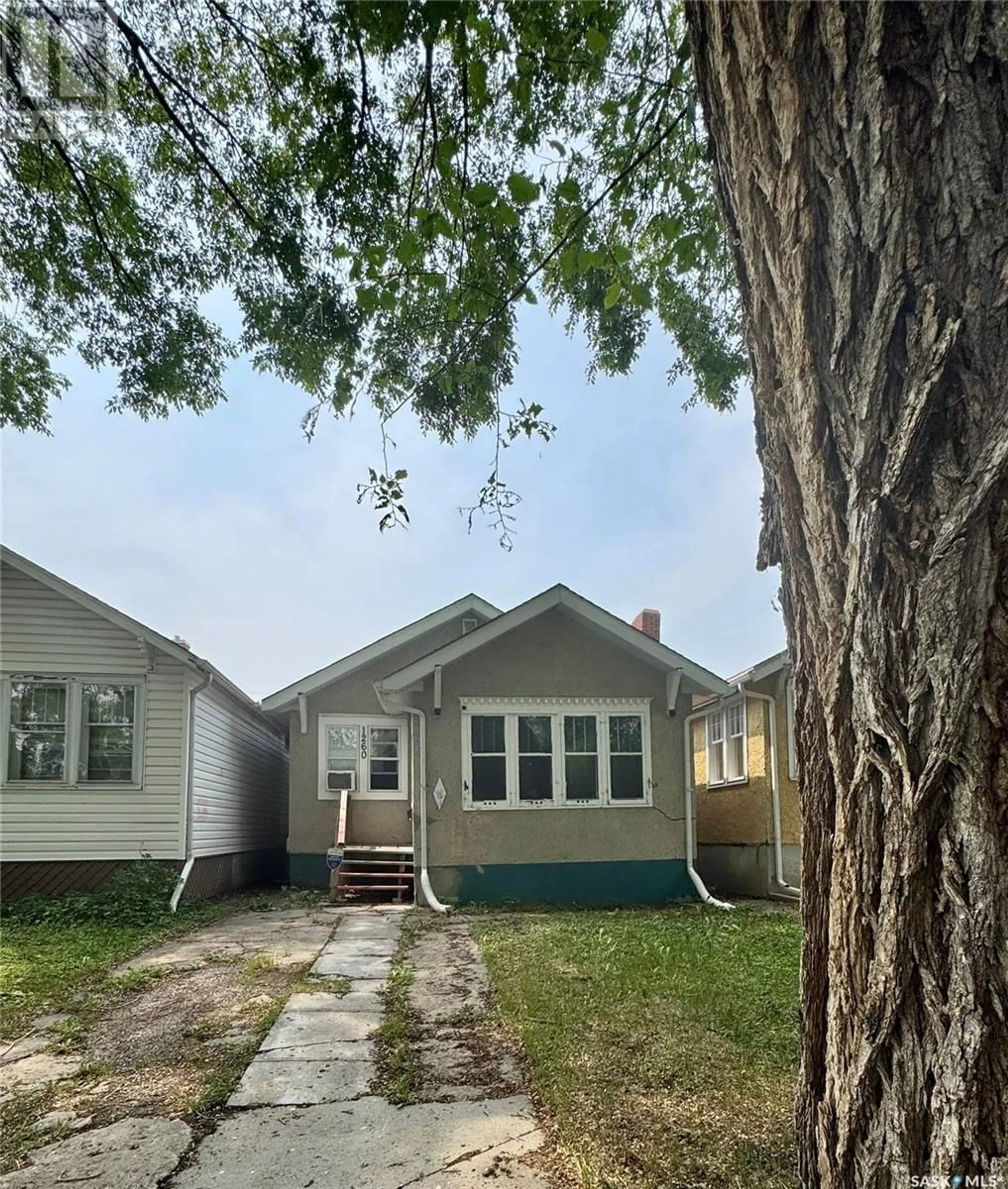 Home with vinyl exterior material, street for 1260 ROBINSON STREET, Regina Saskatchewan S4T2N2