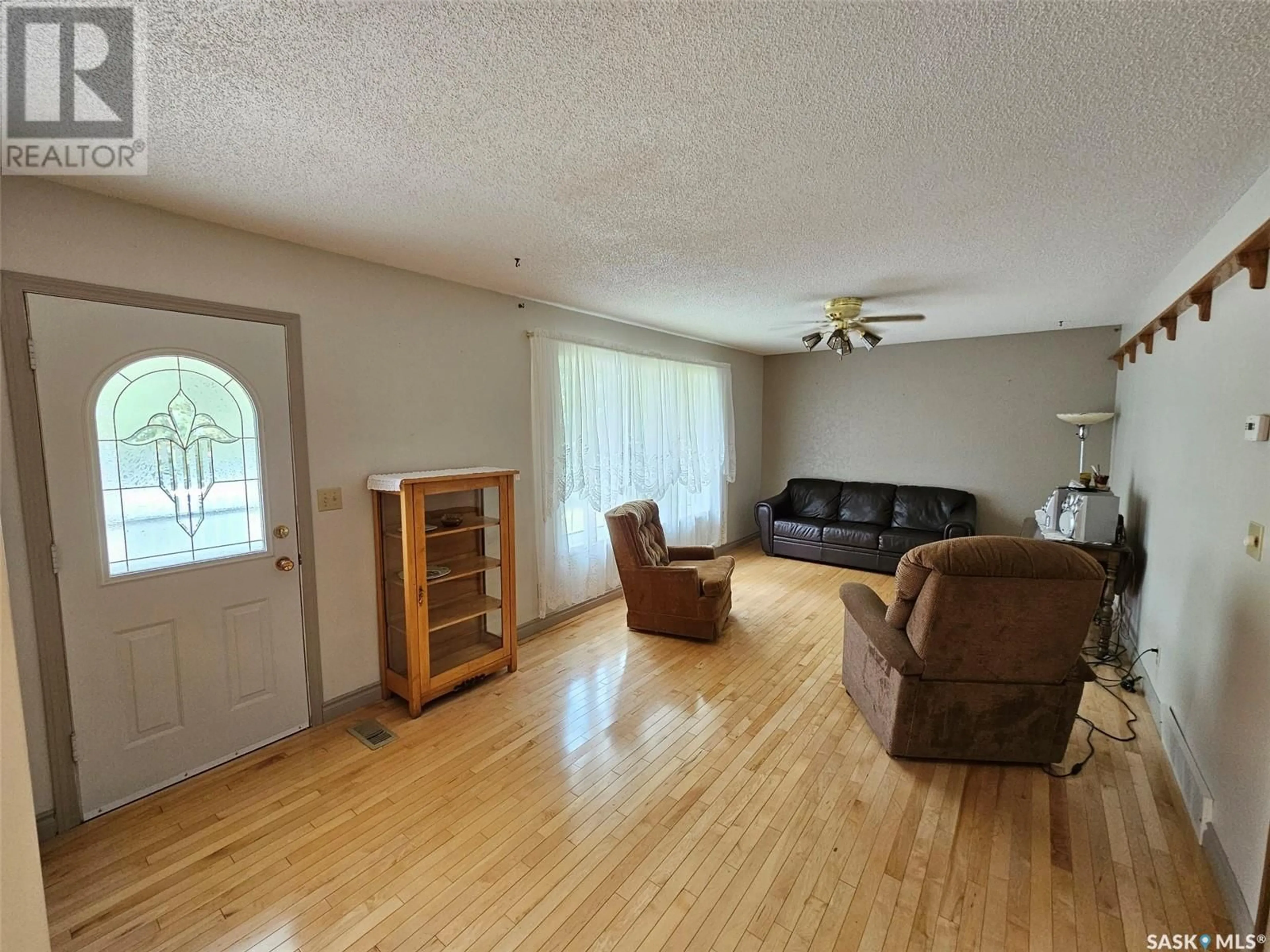 Living room with furniture, wood/laminate floor for 404 MANOR STREET, Arcola Saskatchewan S0C0G0