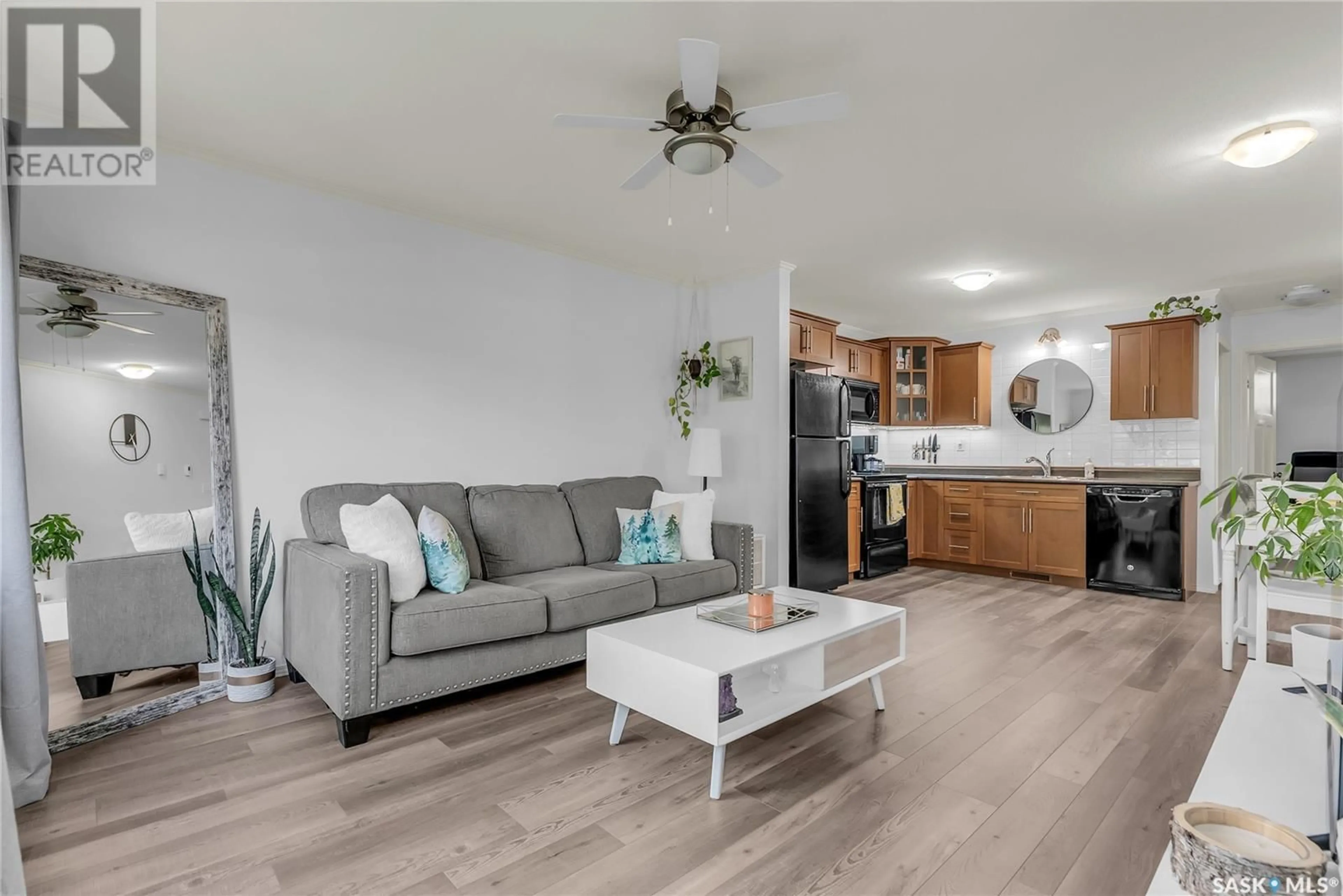 Living room with furniture, wood/laminate floor for 207 - 115 DALGLEISH LINK, Saskatoon Saskatchewan S7W0N5