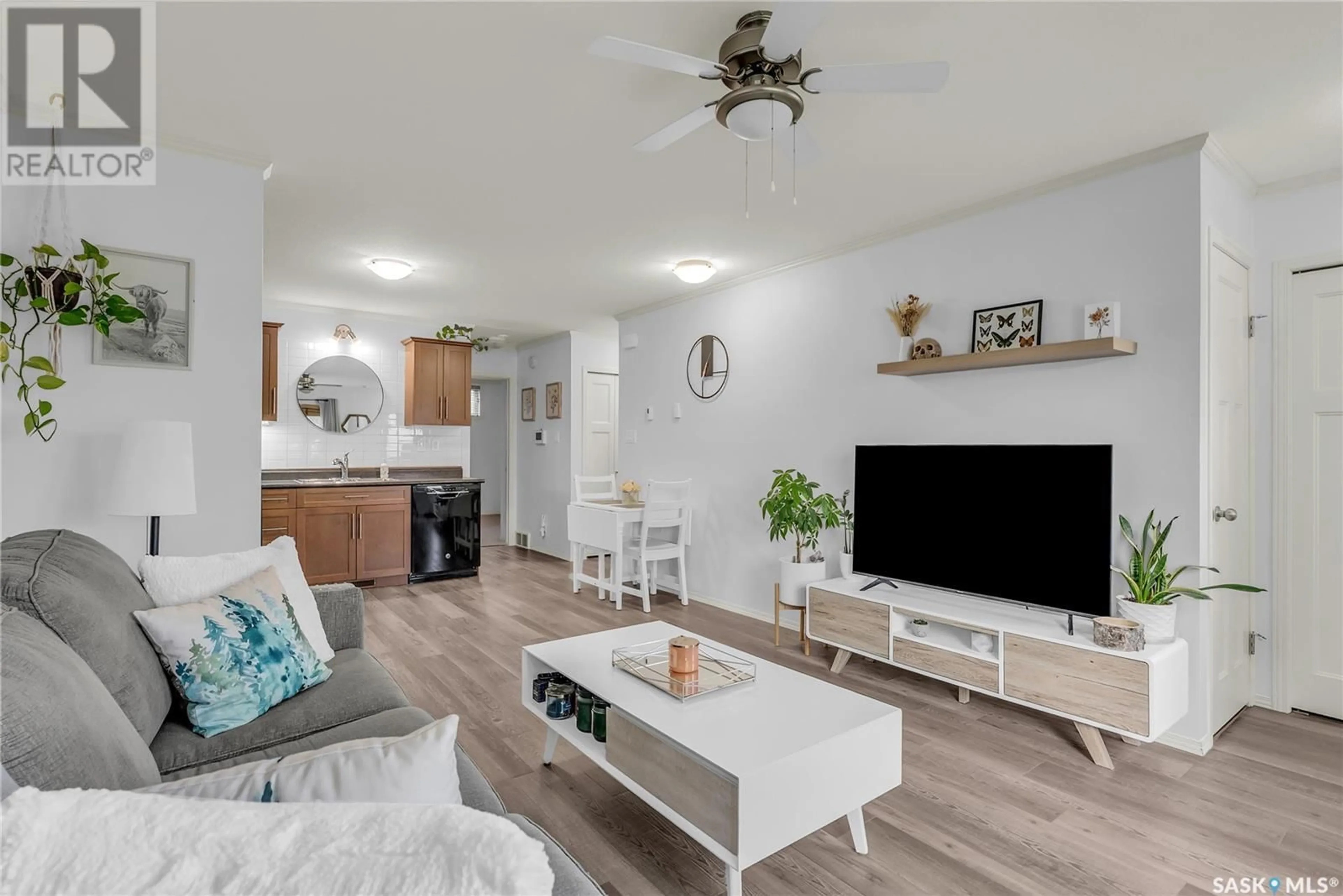 Living room with furniture, wood/laminate floor for 207 - 115 DALGLEISH LINK, Saskatoon Saskatchewan S7W0N5