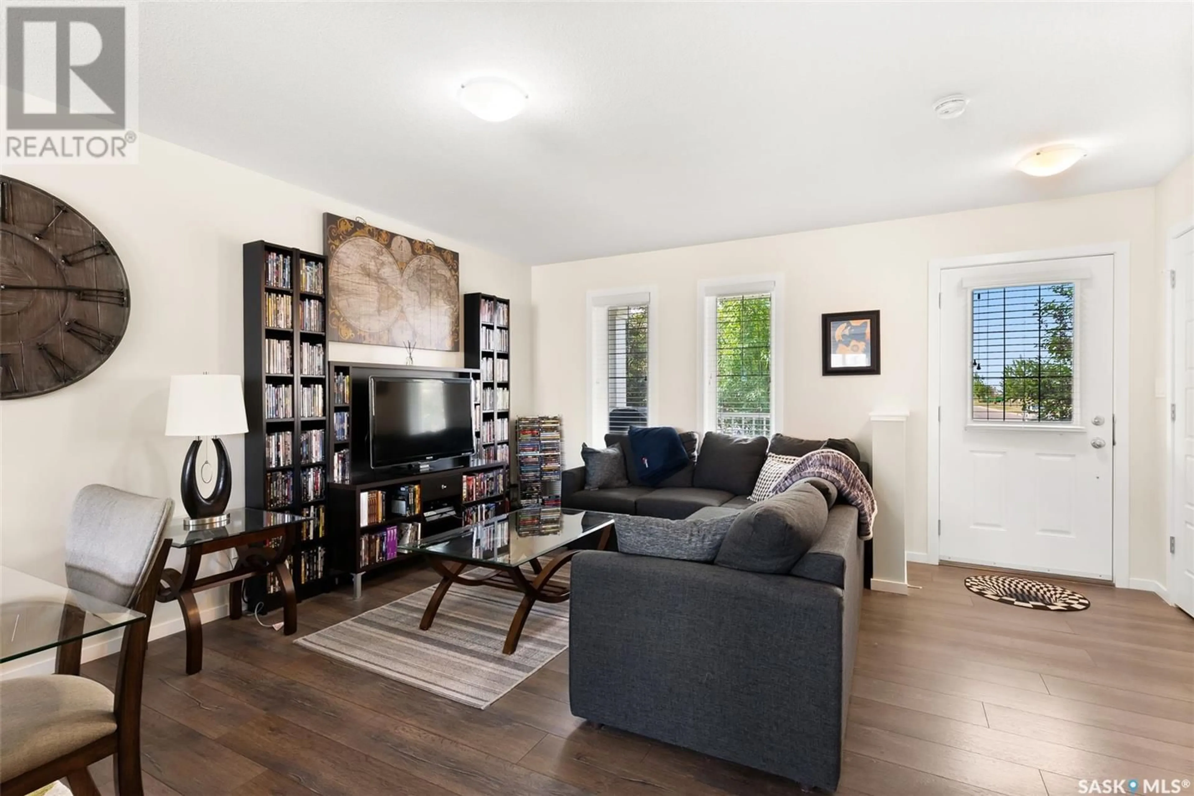 Living room with furniture, wood/laminate floor for 7994 CANOLA AVENUE, Regina Saskatchewan S4Y0E8