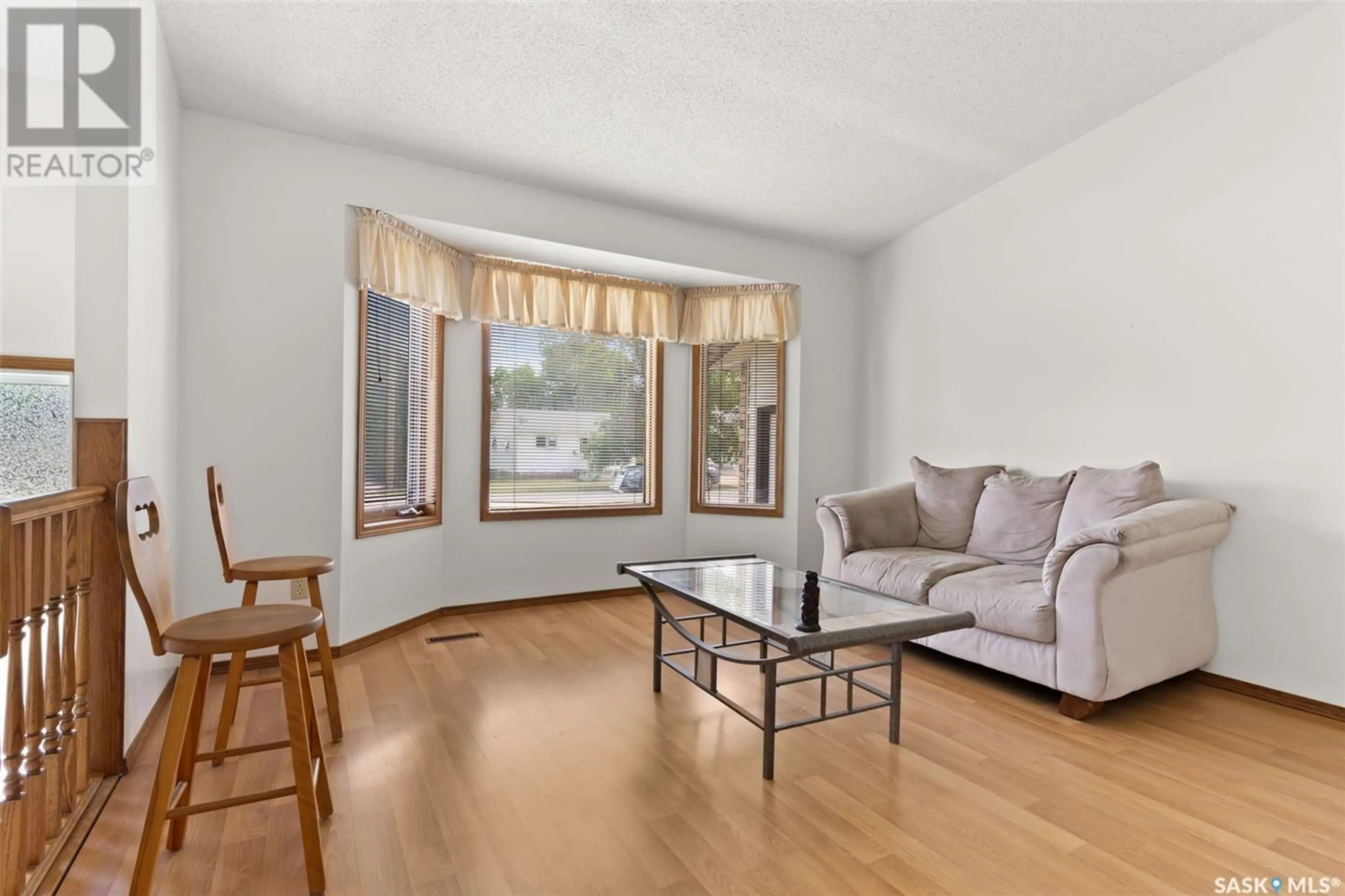 Living room with furniture, wood/laminate floor for 125 SOLBERG STREET, Milestone Saskatchewan S0G3L0