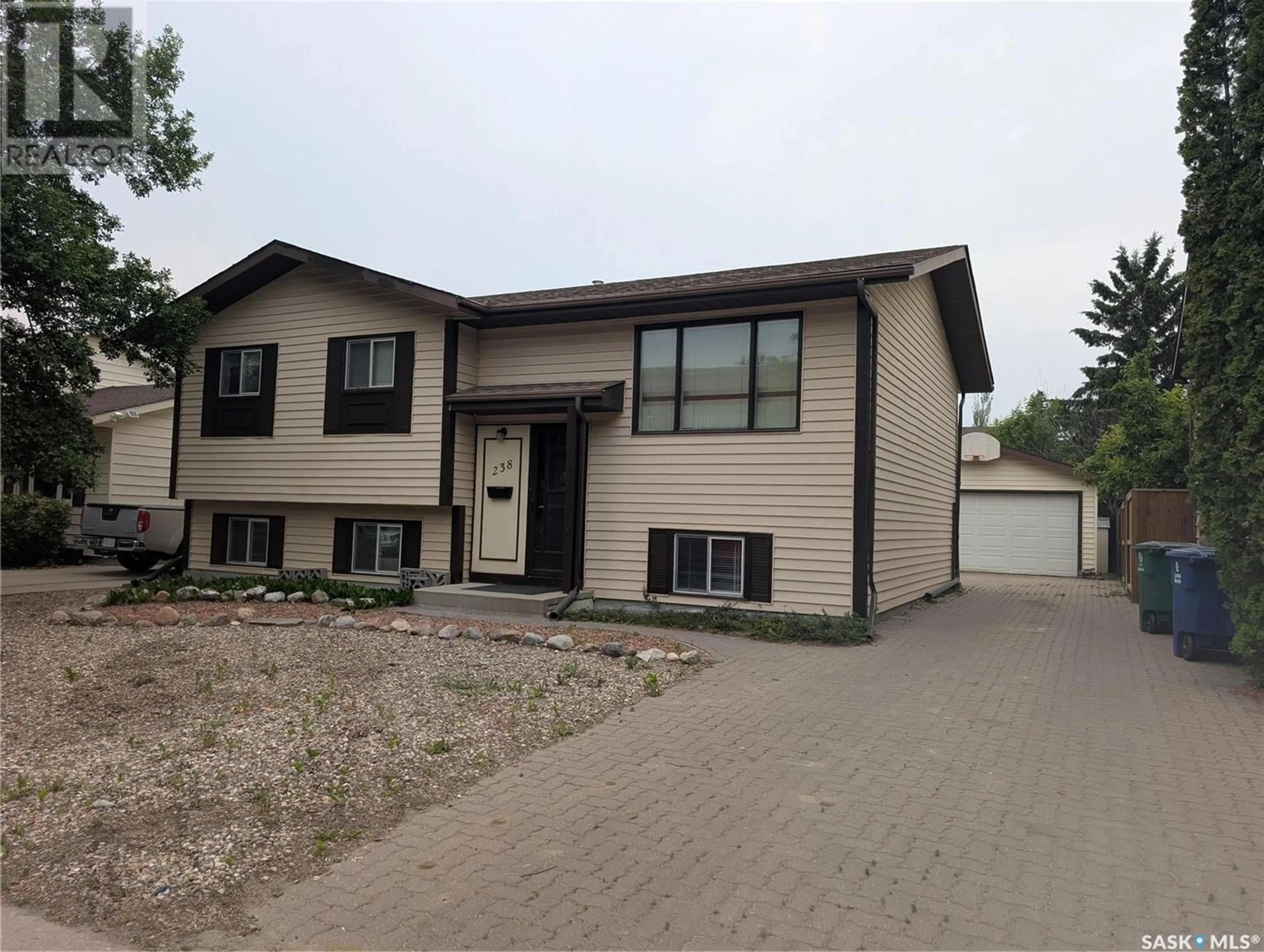 Home with vinyl exterior material, street for 238 STILLWATER DRIVE, Saskatoon Saskatchewan S7J4K3
