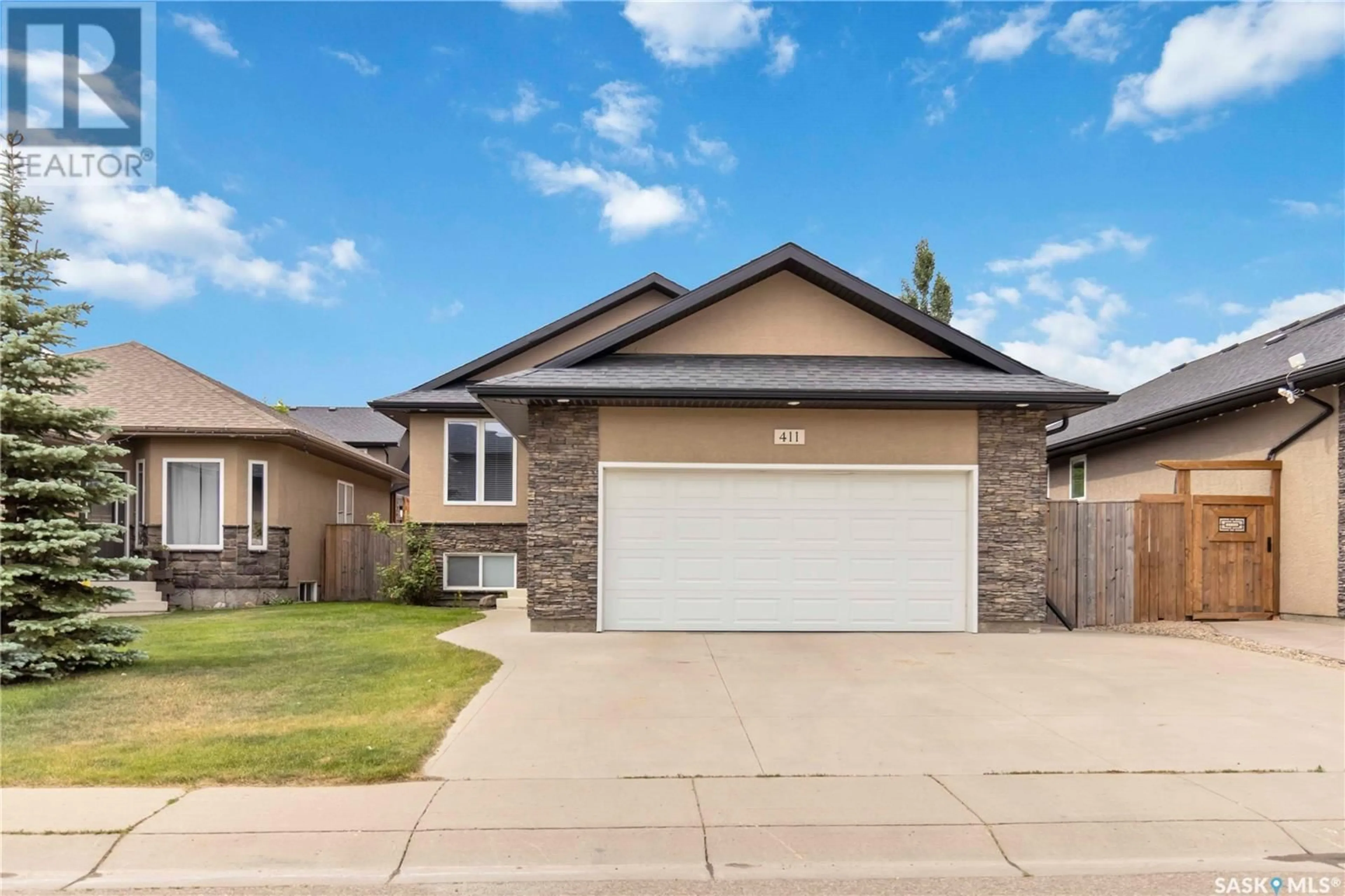 Home with vinyl exterior material, street for 411 REMPEL LANE, Saskatoon Saskatchewan S7T0J3