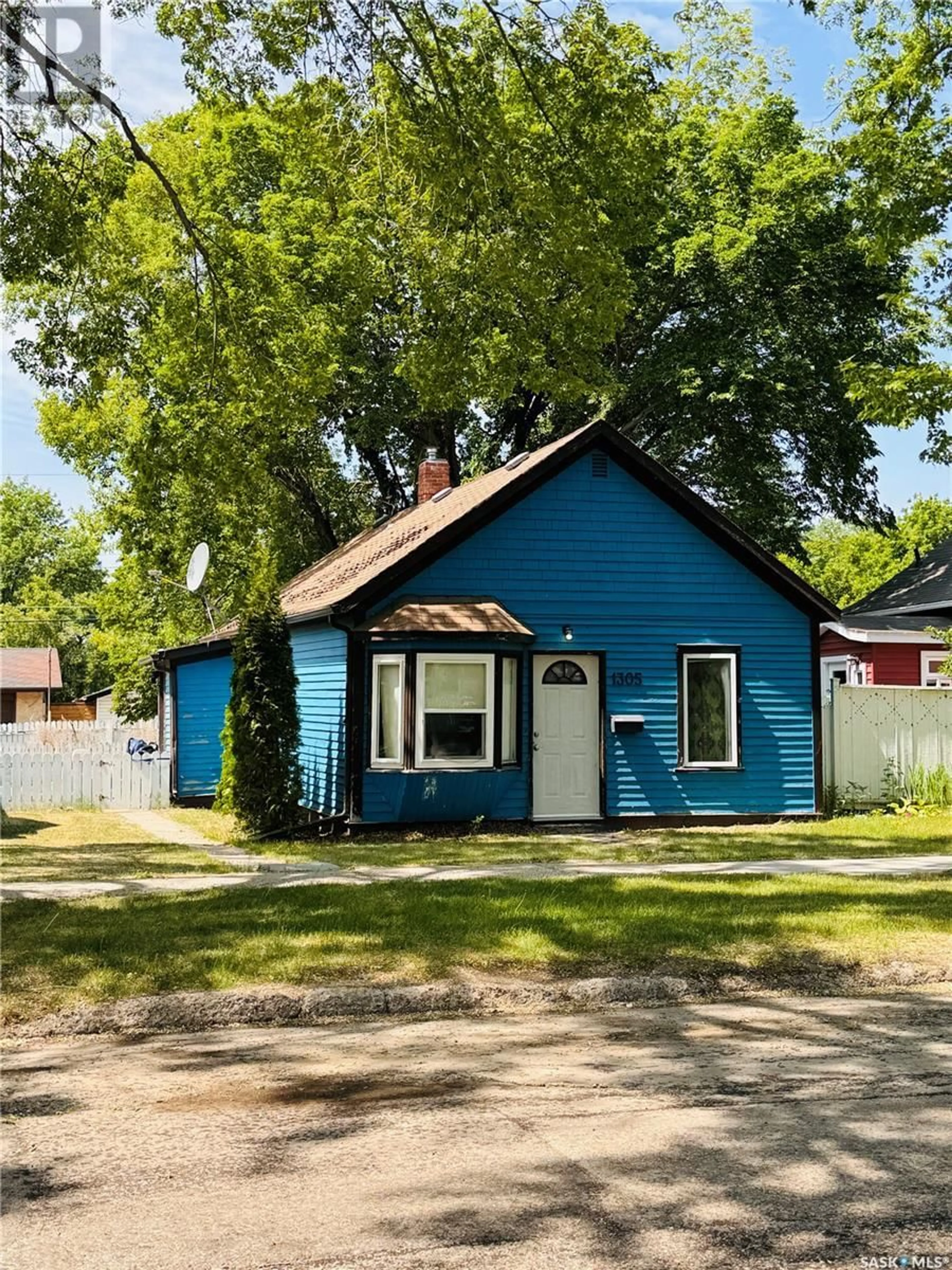 Home with vinyl exterior material, street for 1305 G AVENUE, Saskatoon Saskatchewan S7L2A6