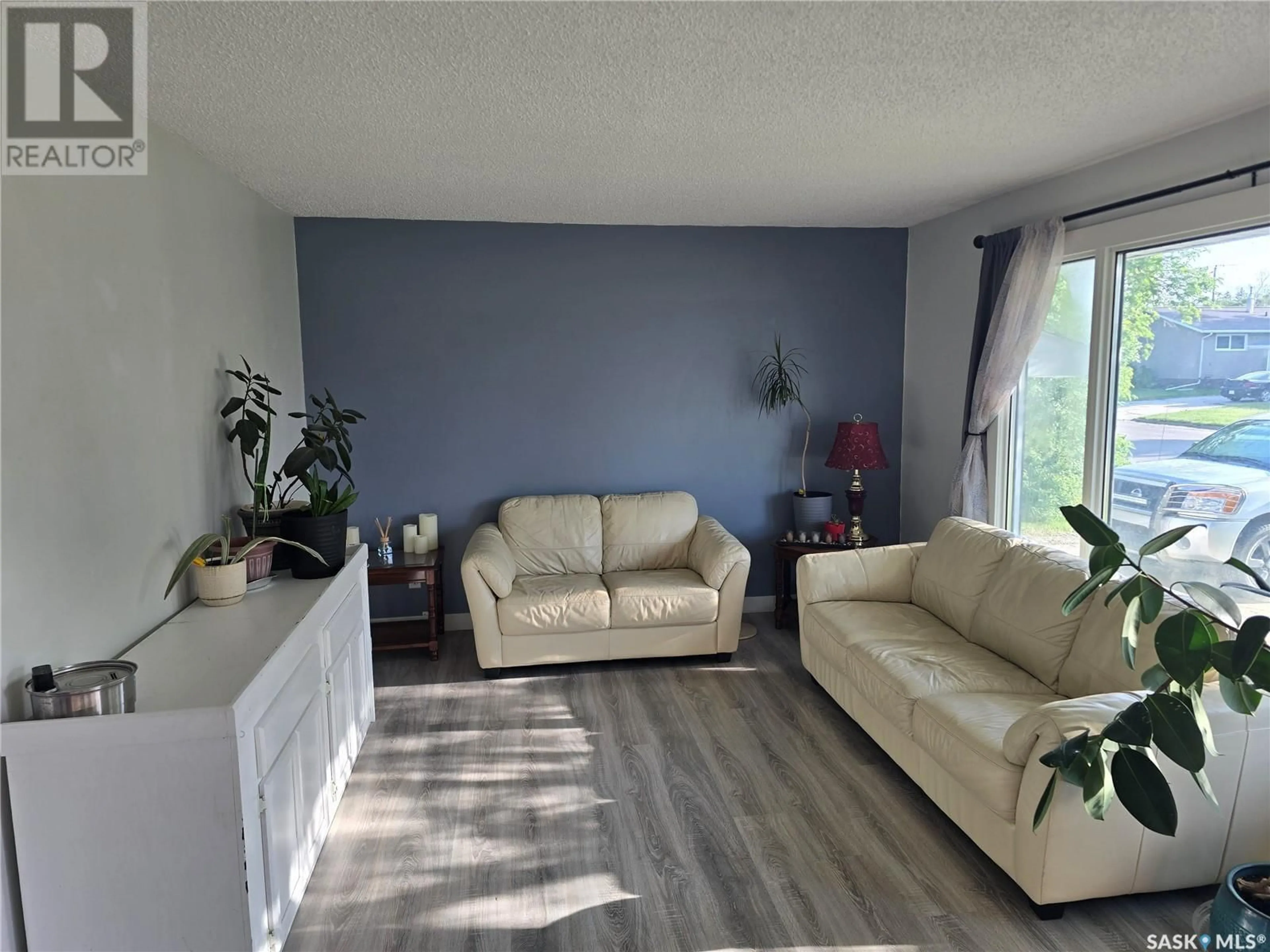 Living room with furniture, wood/laminate floor for 212 8TH STREET, Wynyard Saskatchewan S0A4T0