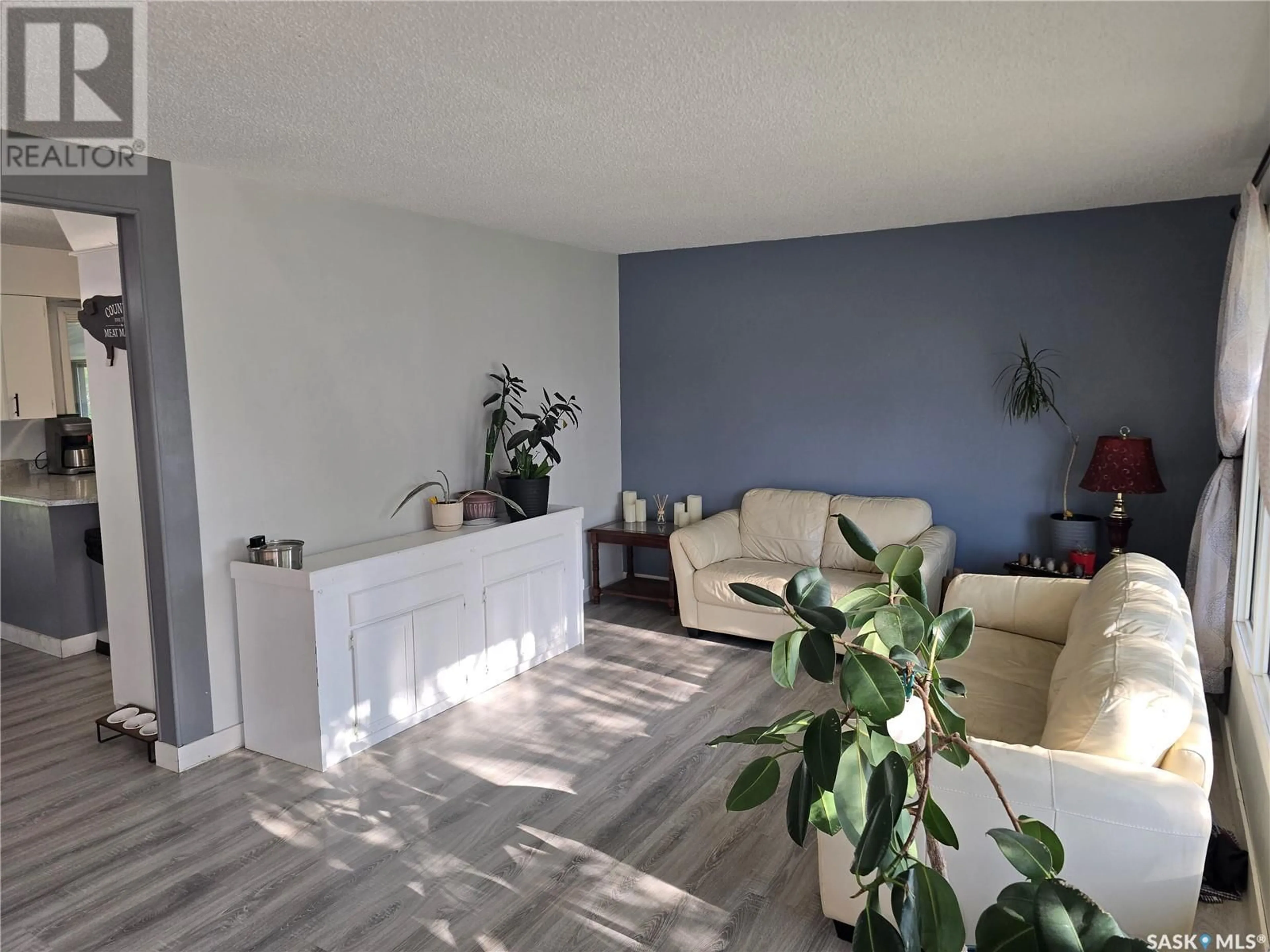 Living room with furniture, wood/laminate floor for 212 8TH STREET, Wynyard Saskatchewan S0A4T0