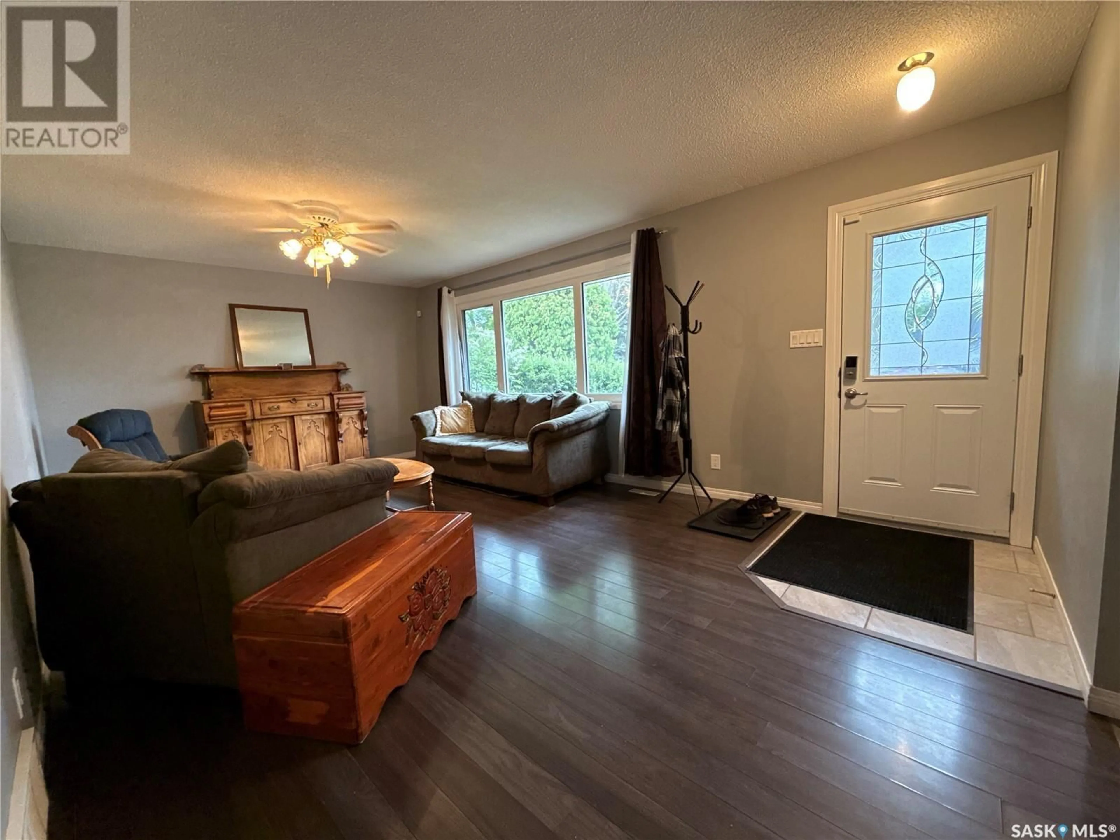 Living room with furniture, wood/laminate floor for 203 WINNIPEG AVENUE, Saskatoon Saskatchewan S7L3P3