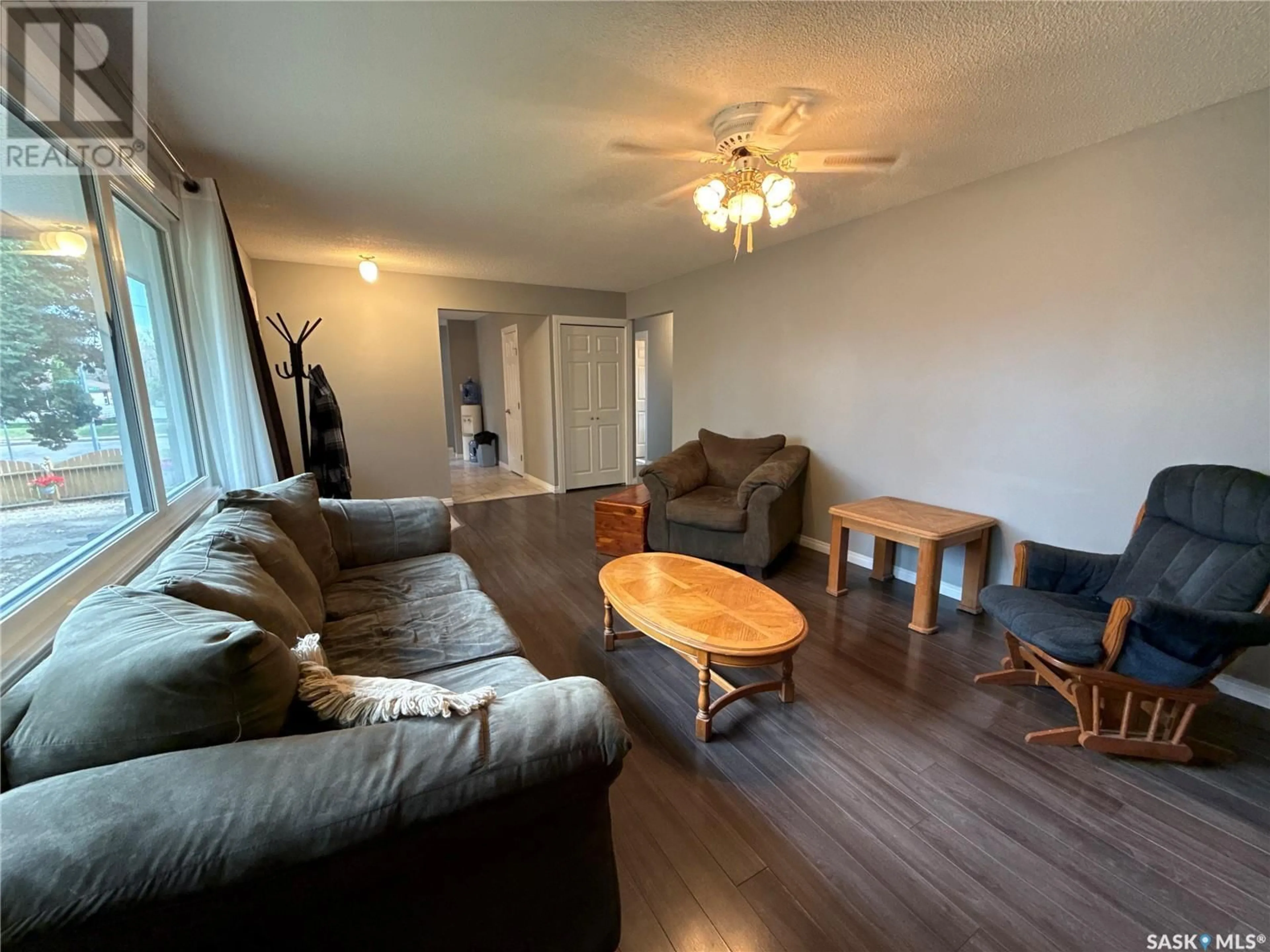 Living room with furniture, wood/laminate floor for 203 WINNIPEG AVENUE, Saskatoon Saskatchewan S7L3P3