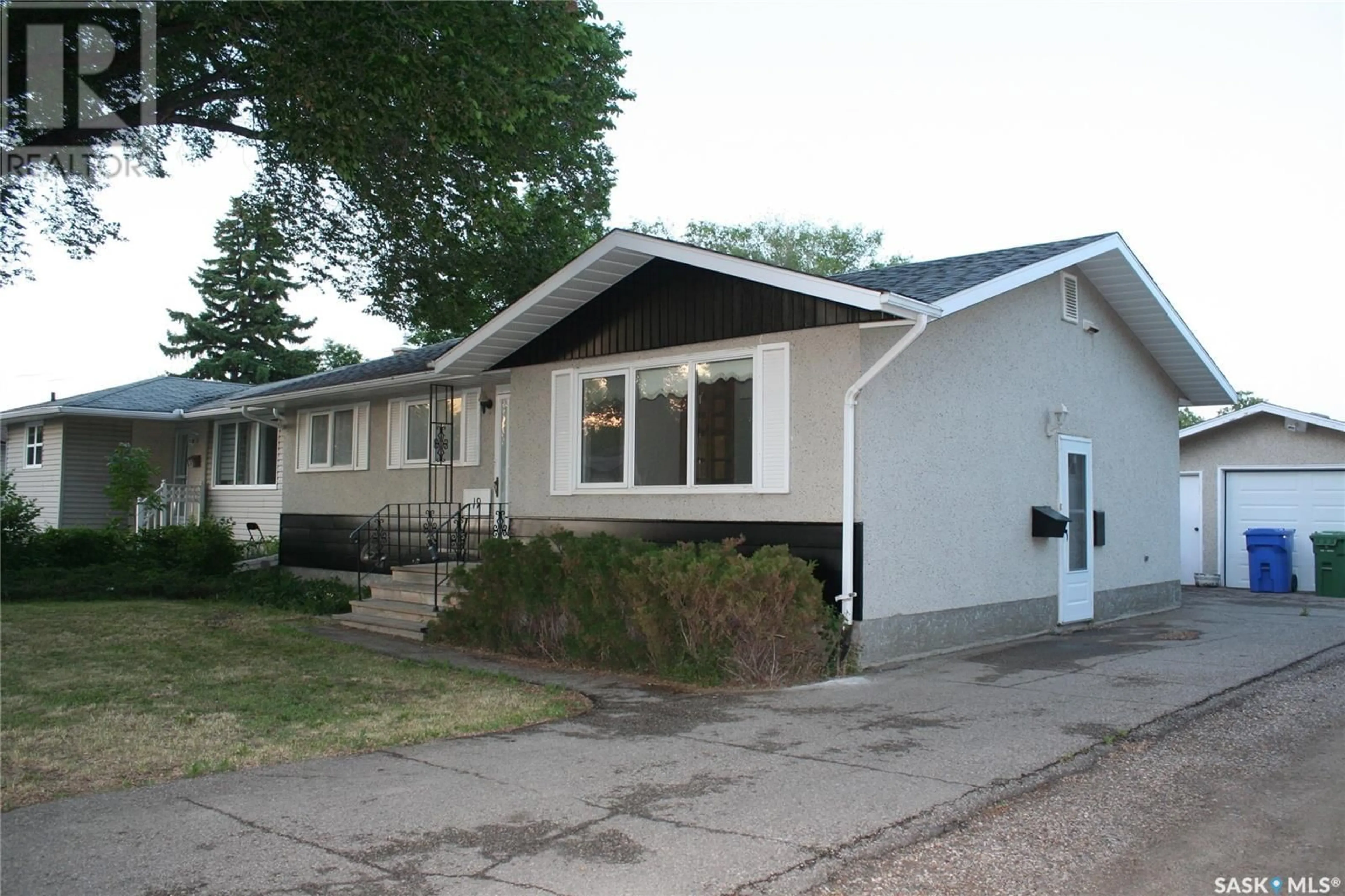 Home with vinyl exterior material, street for 19 MERLIN CRESCENT, Regina Saskatchewan S4R3E7